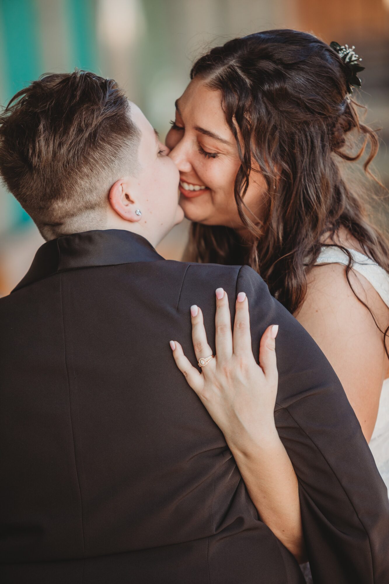 A woman and a young boy are close, smiling and touching faces, with the woman's hand on the boy's shoulder.