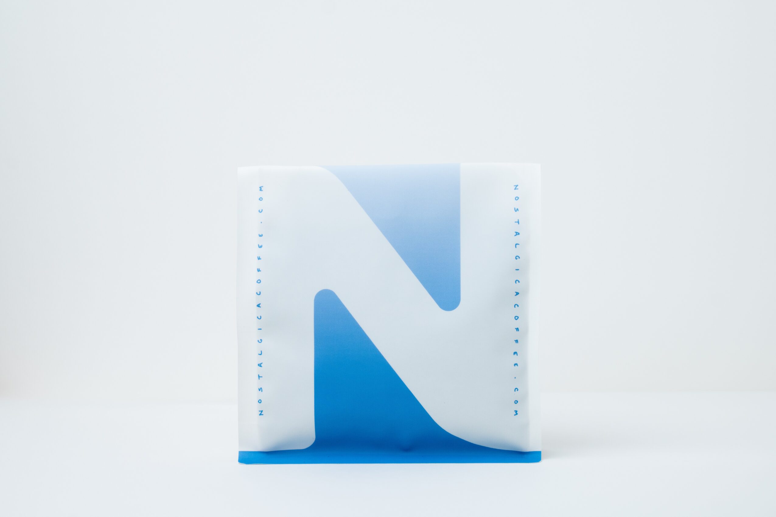 A white box with a blue letter 'N' on it, placed on a white surface against a white background.