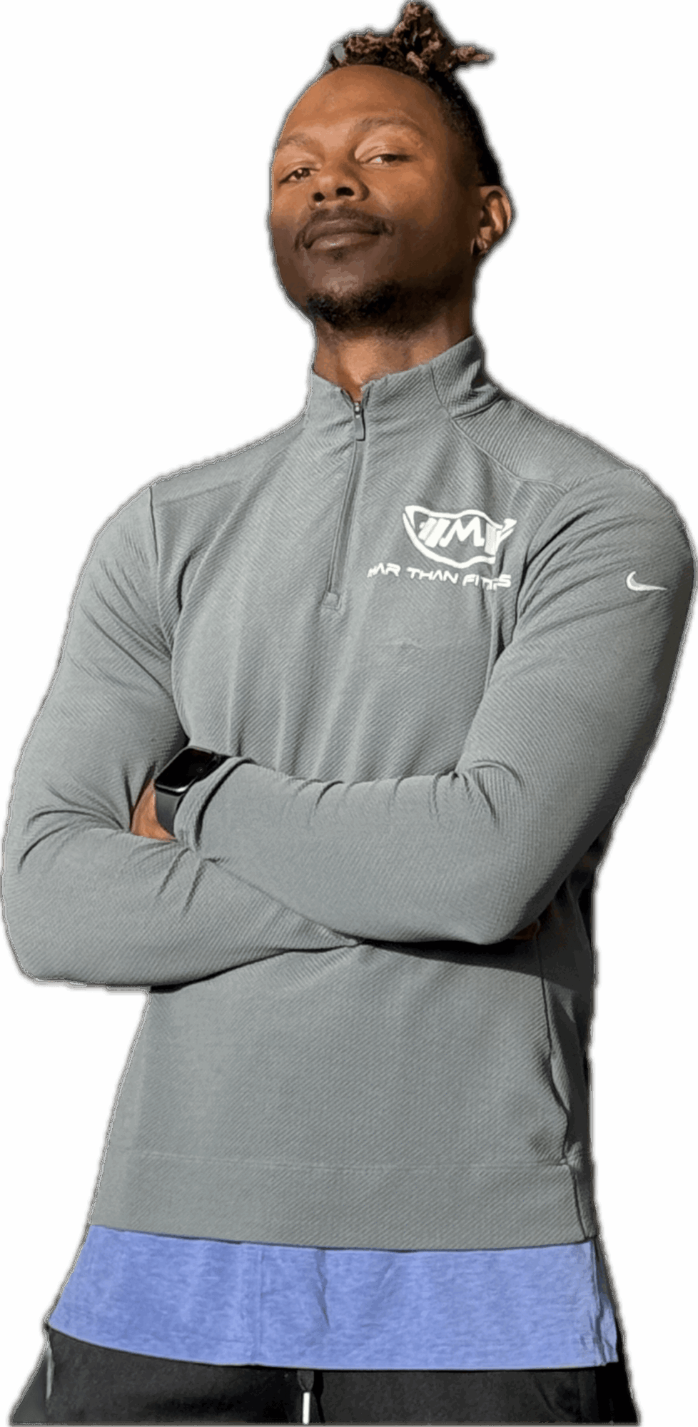 Person with arms crossed, wearing a gray athletic jacket and standing against a black background.