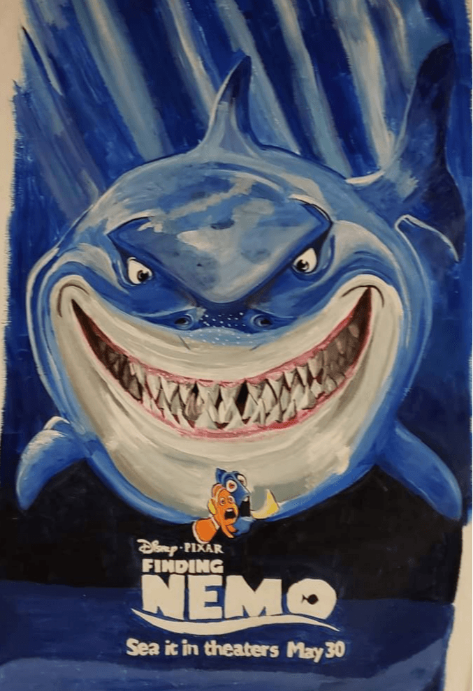 Animated shark with a wide, toothy grin, set against a blue background, promoting the movie Finding Nemo, releasing May 30.