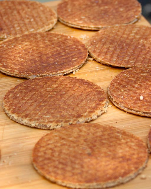 Several round waffles with a grid pattern on a wooden surface.
