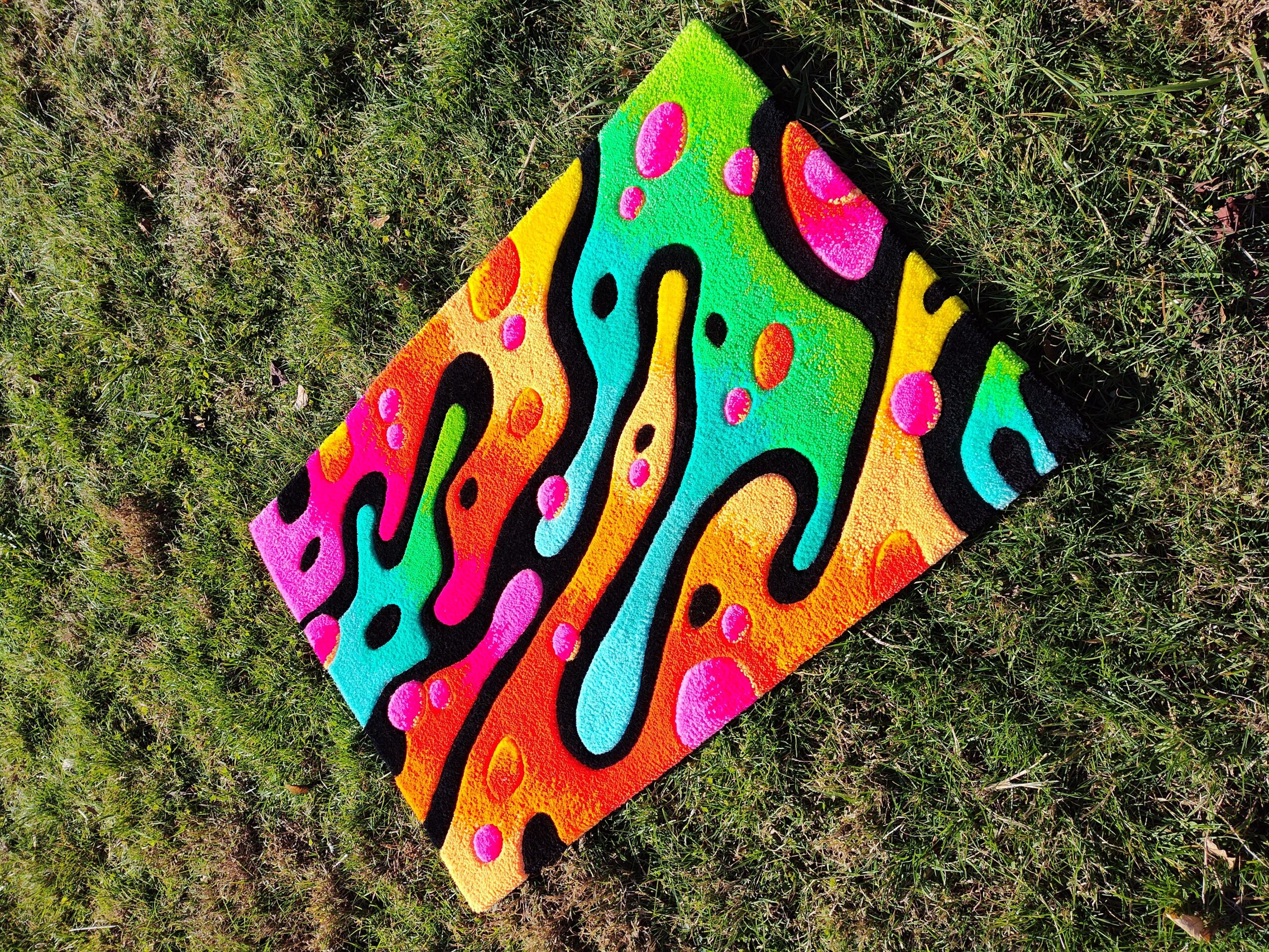 Colorful abstract pattern with wavy shapes and dots on a grassy background.