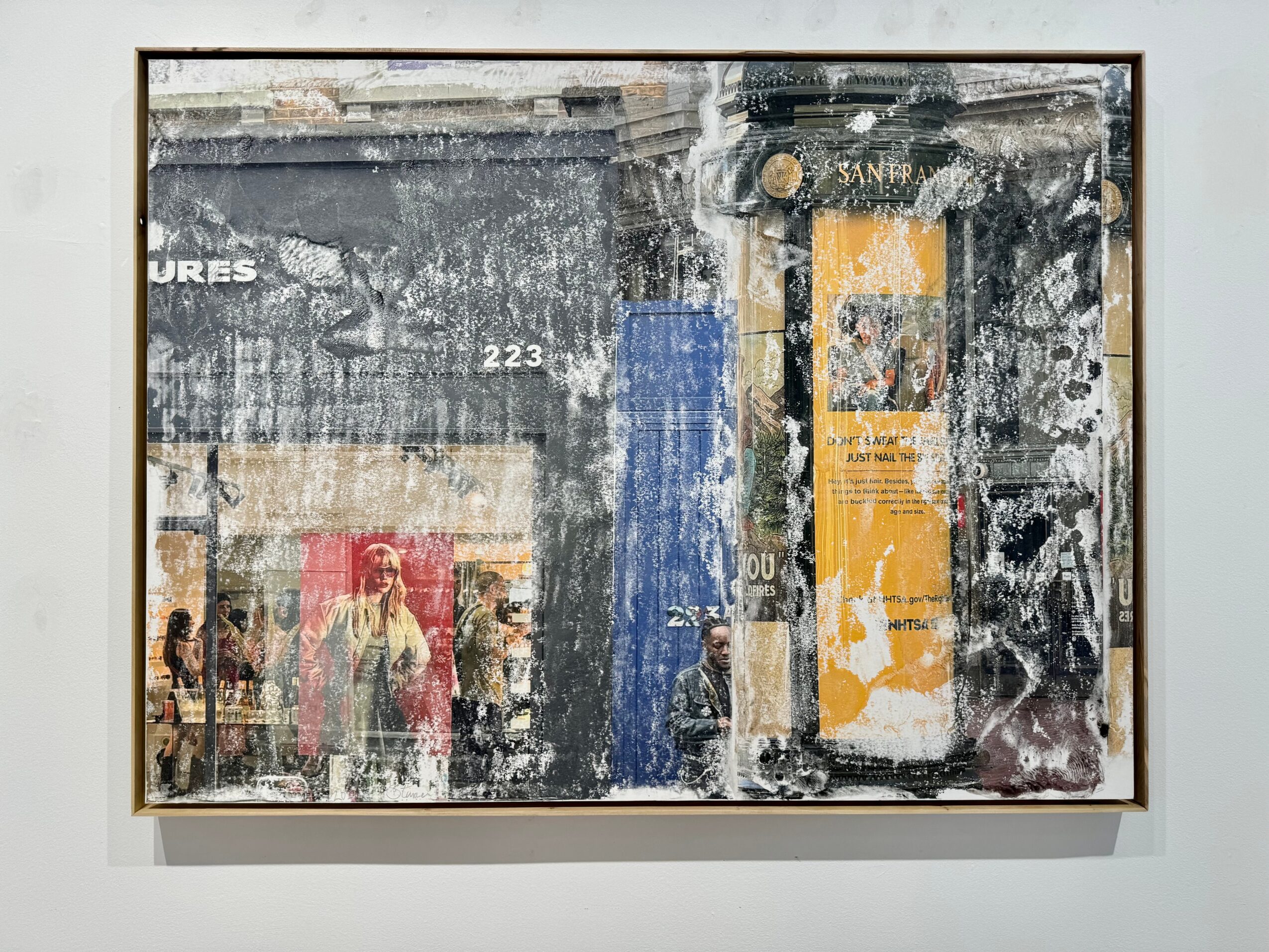 Abstract artwork with layered textures and colors, including black, yellow, blue, and red, with visible signs of wear and tear.