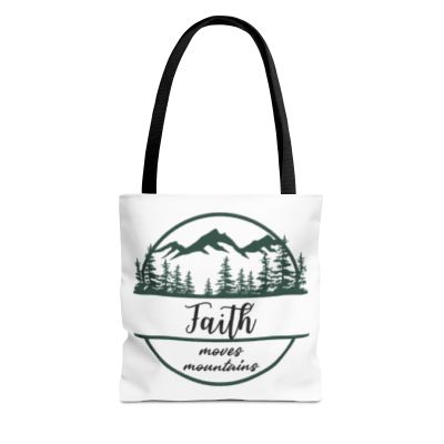 White tote bag with mountain, trees, and text reading Faith moves mountain, simple design, black handles.