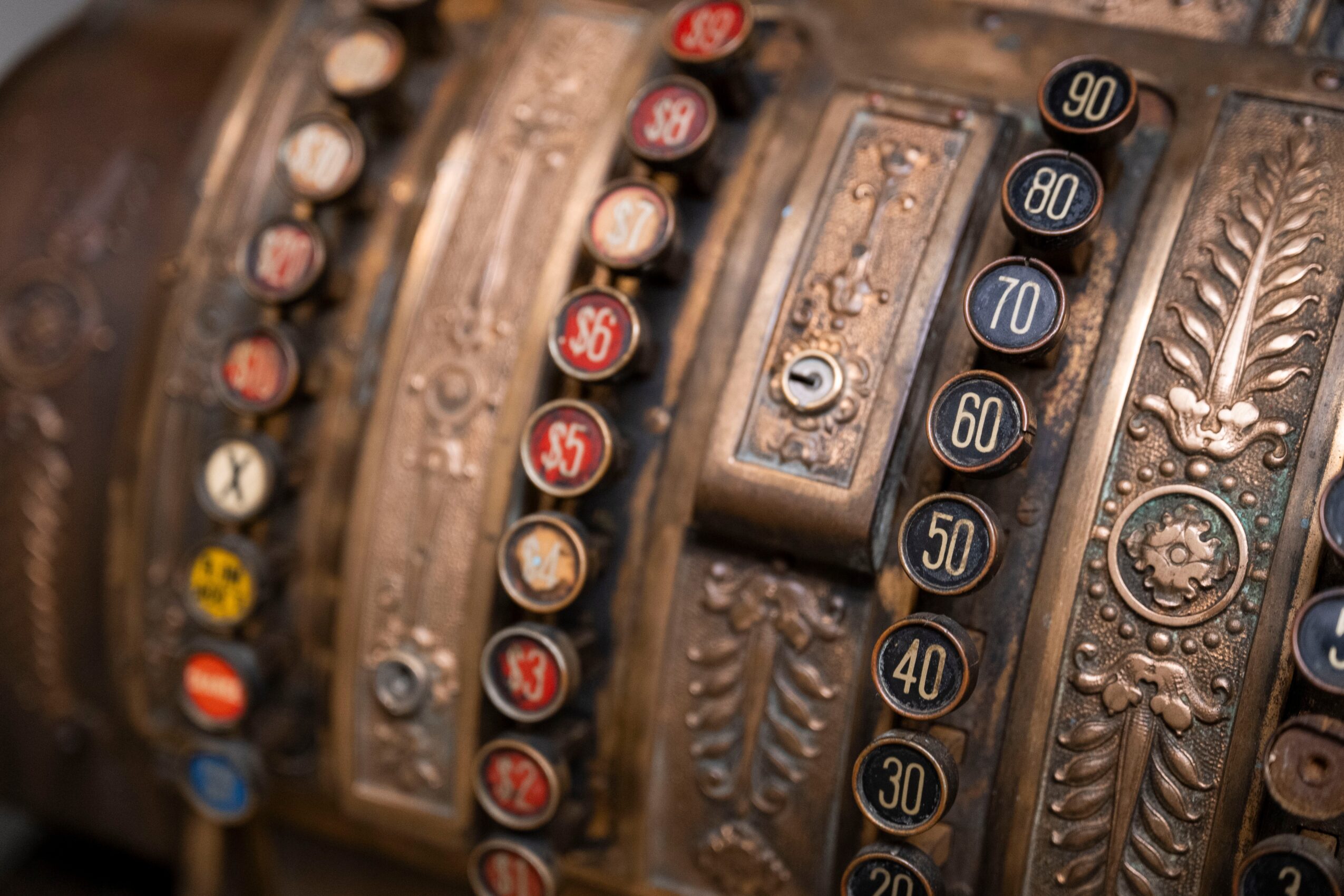 Close-up of vintage mechanical counter with numbered dials and ornate decorative elements.