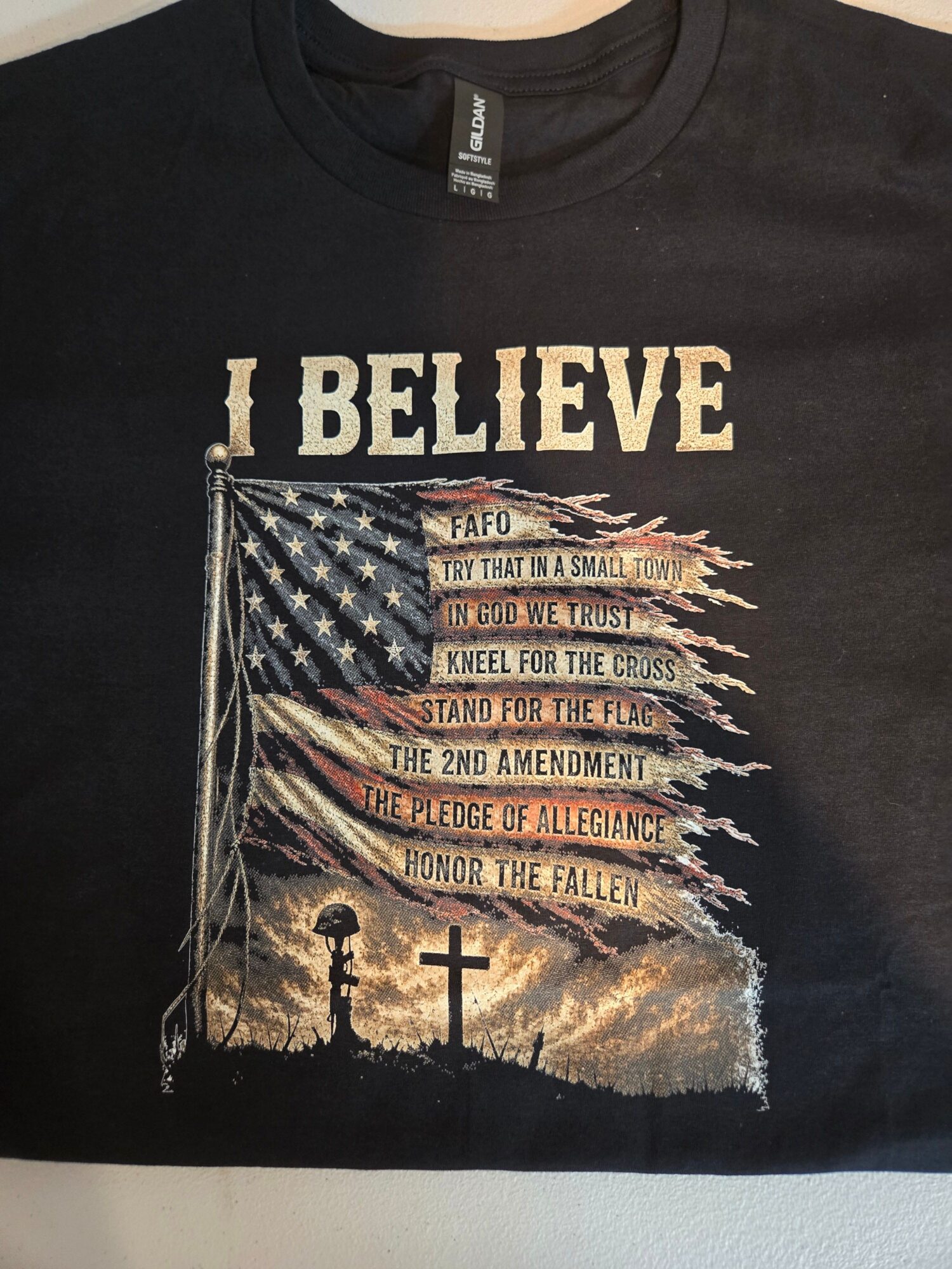Black T-shirt with an American flag and the words