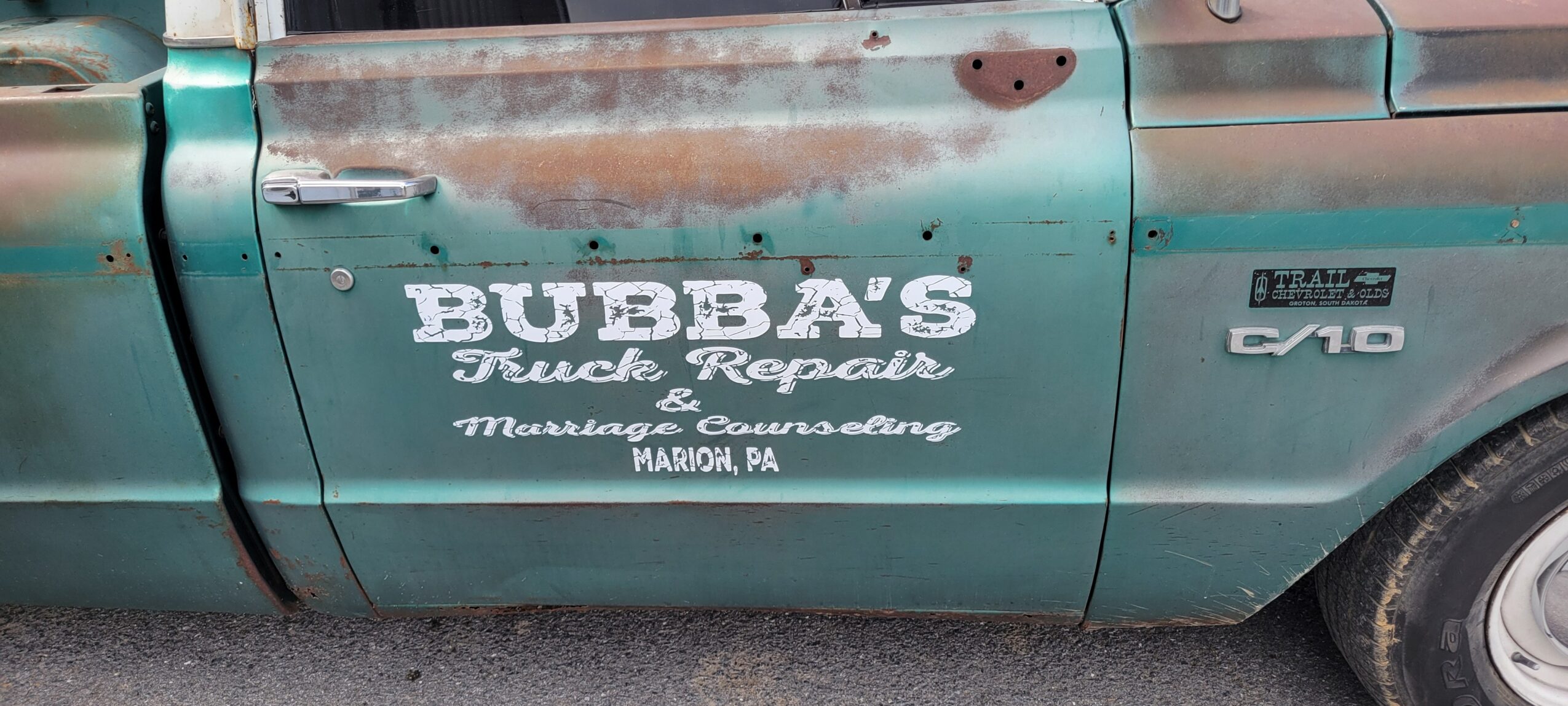 Green truck with white lettering advertising Bubba's Truck Repair in Marion, Pennsylvania.