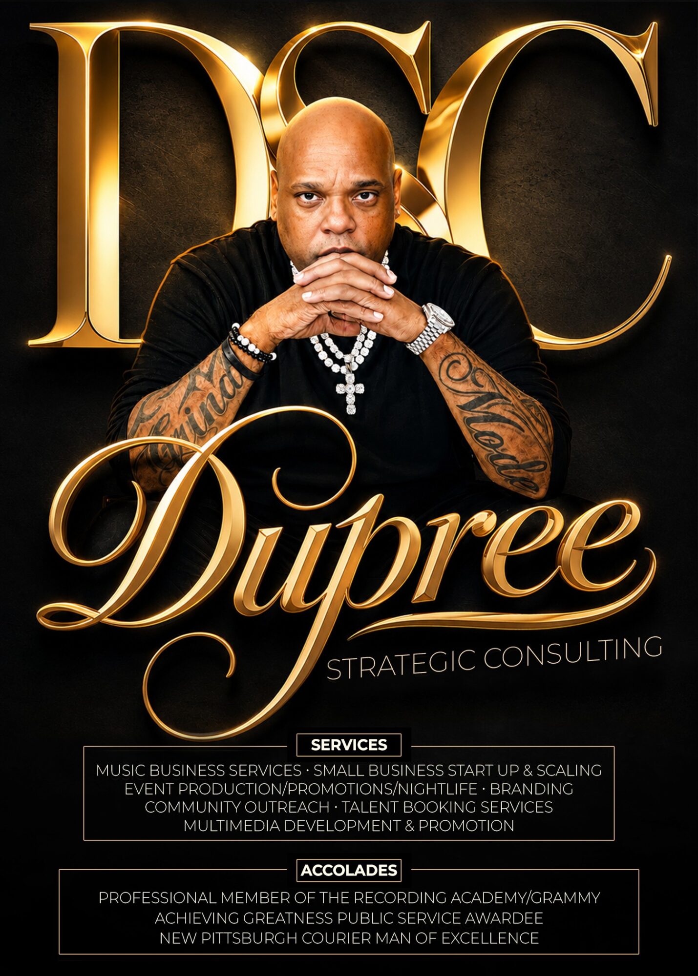Bald man with tattoos, wearing a black shirt and jewelry, sitting with hands clasped, in front of a gold logo background.