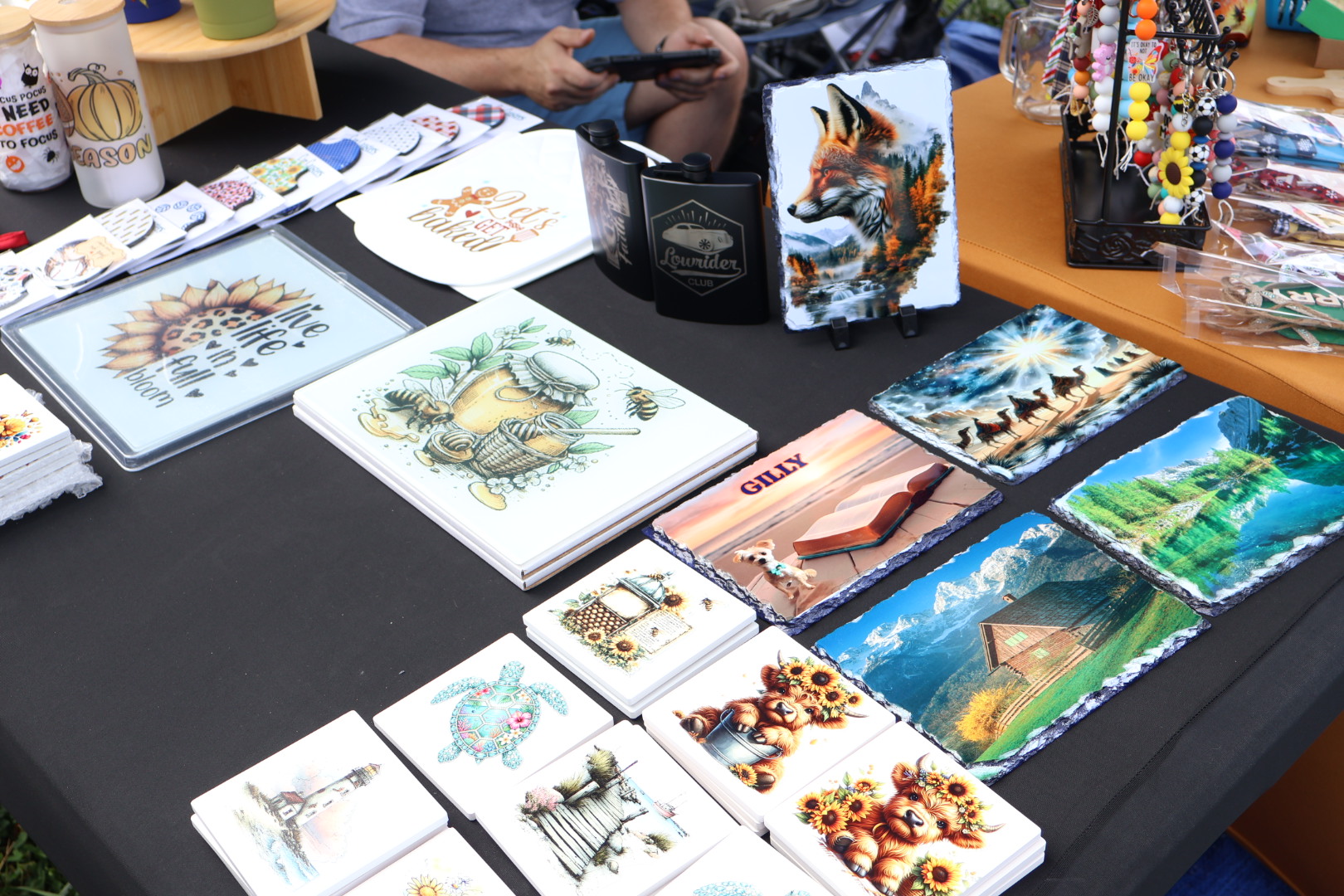 Table displaying various illustrated books, postcards, and souvenirs with colorful artwork and designs.