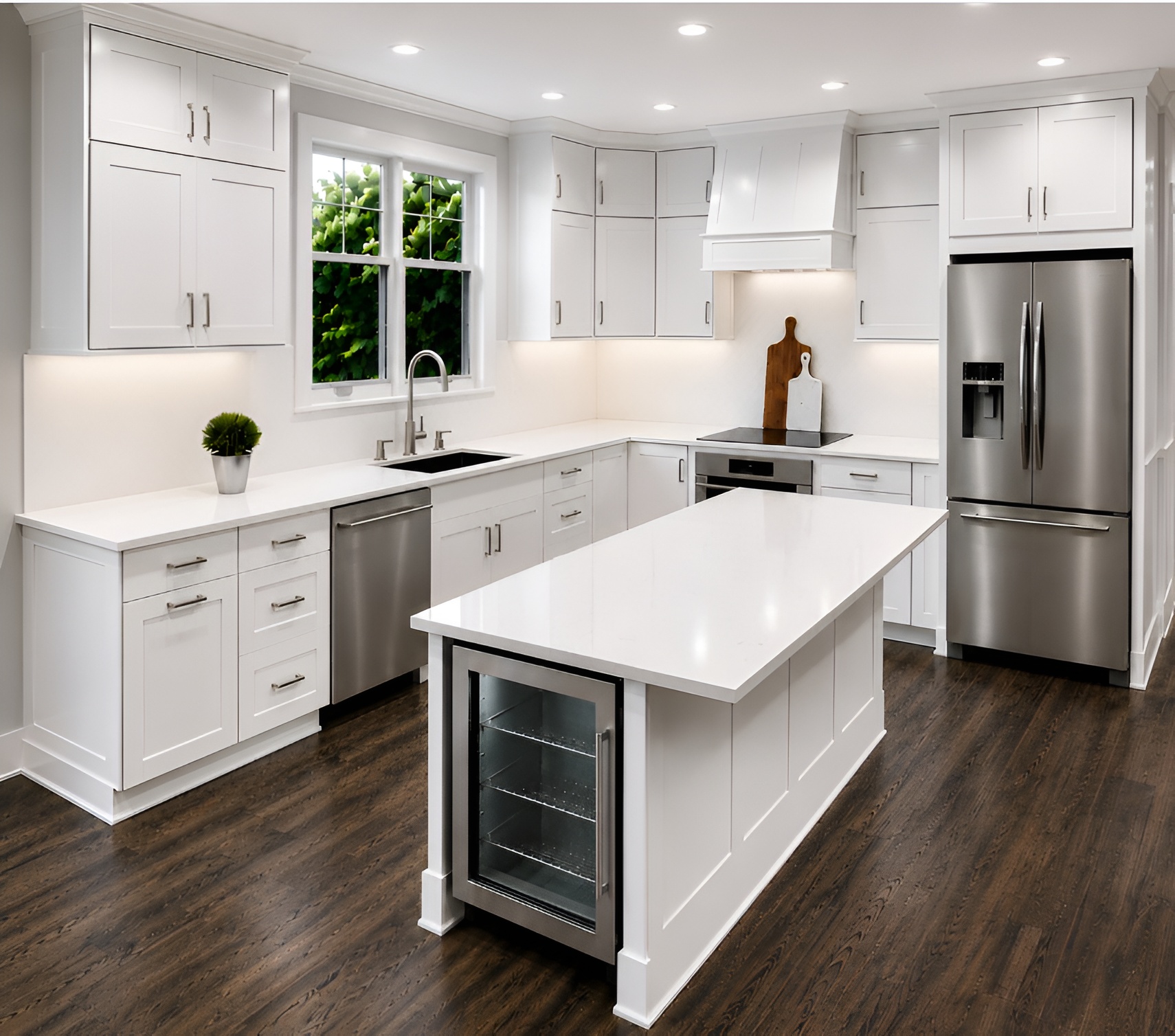 Modern kitchen with white cabinets, island, stainless steel appliances, and dark wood flooring, illuminated by natural light from two windows.