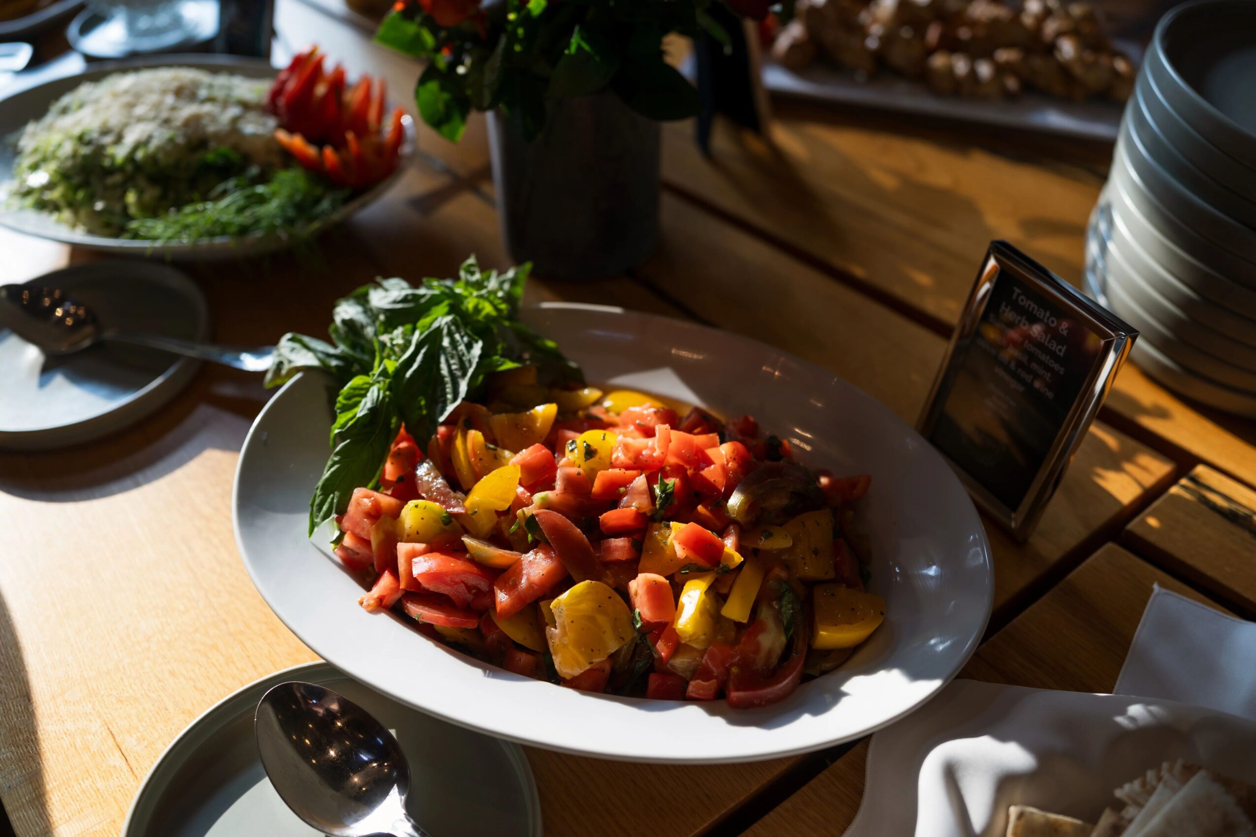 Plate of diced fruit salad with pineapple, watermelon, and other fruits on a table, with a smartphone nearby.