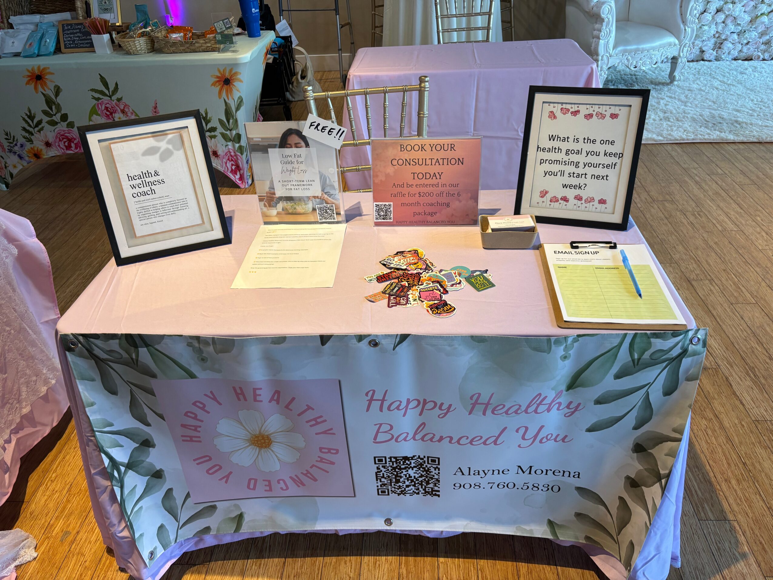 Table with health and wellness information, flyers, and a banner reading