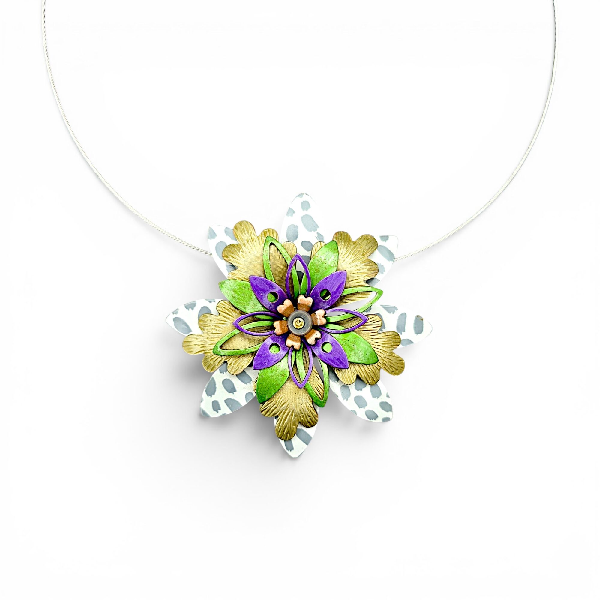 Colorful flower-shaped pendant with purple, green, and gold elements on a white background.
