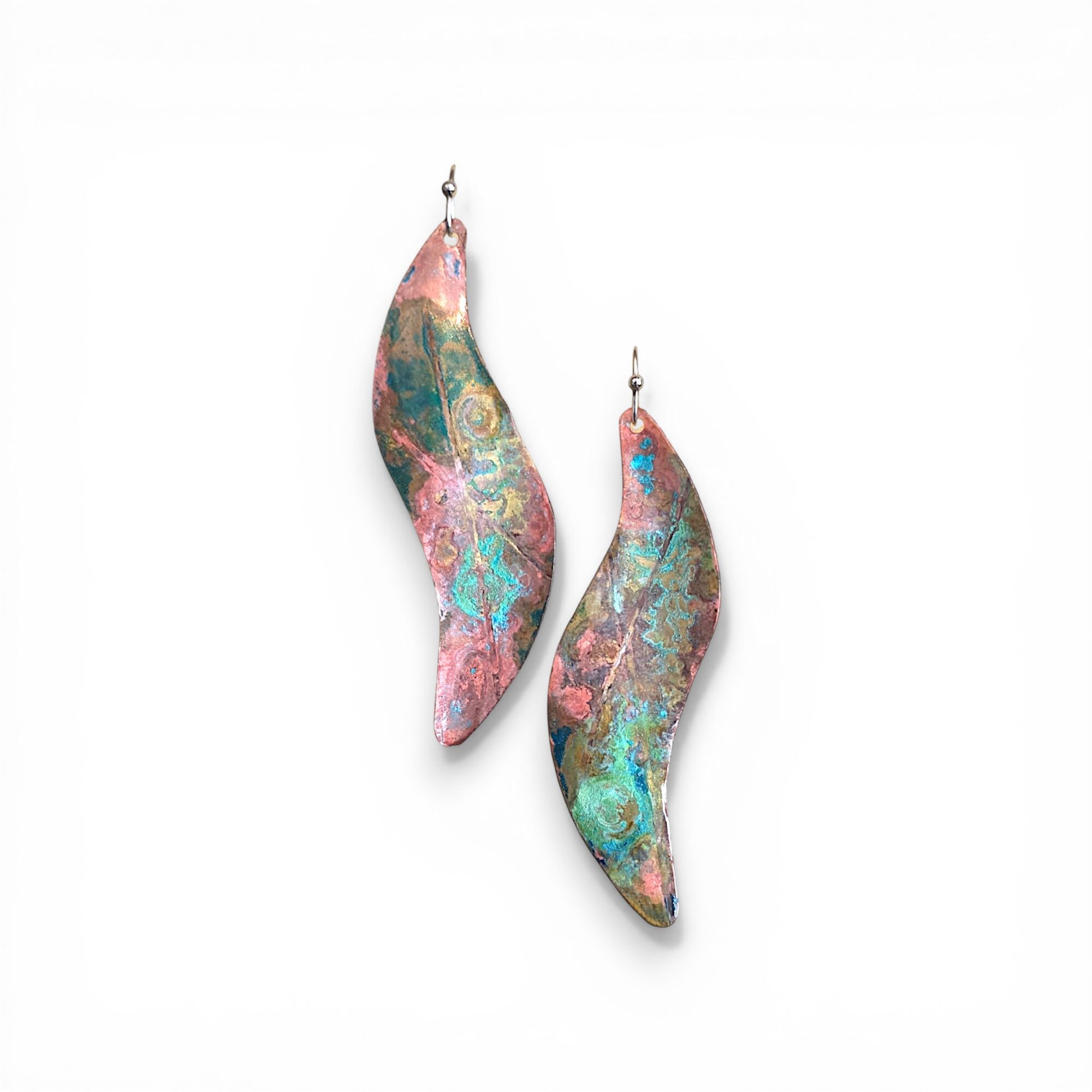 Colorful, abstract-patterned earrings with hooks, hanging against a white background.