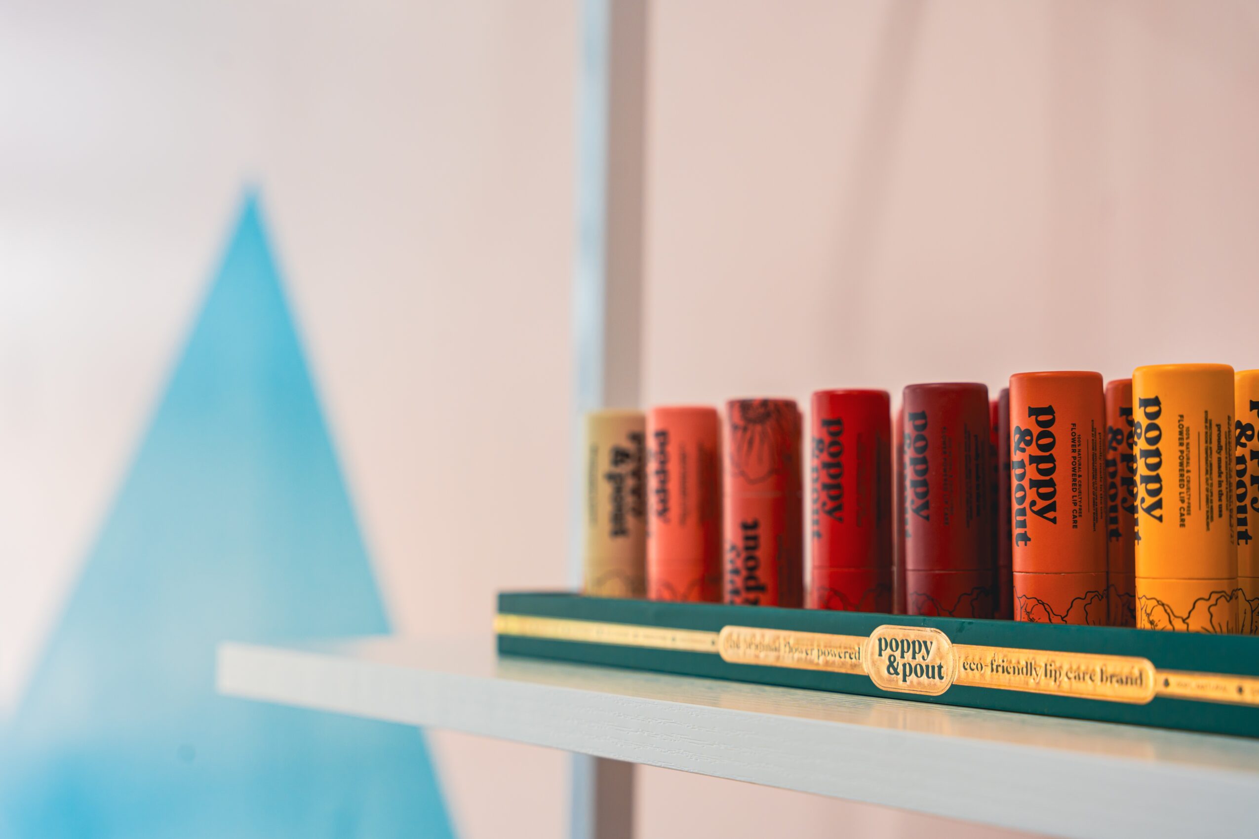 Colorful chalks arranged on a shelf with a blurred background