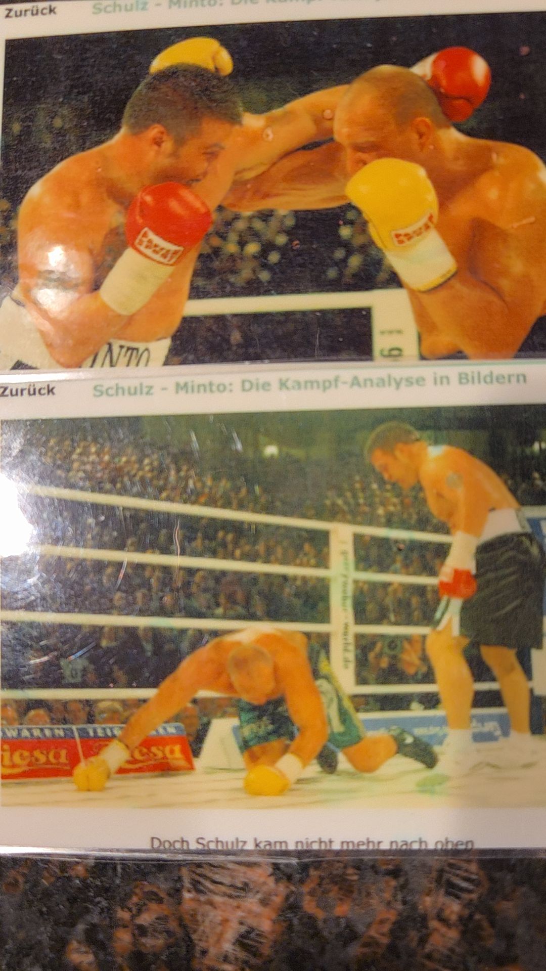 Boxers in ring exchanging punches during match, one on ground, referee nearby, audience in background.