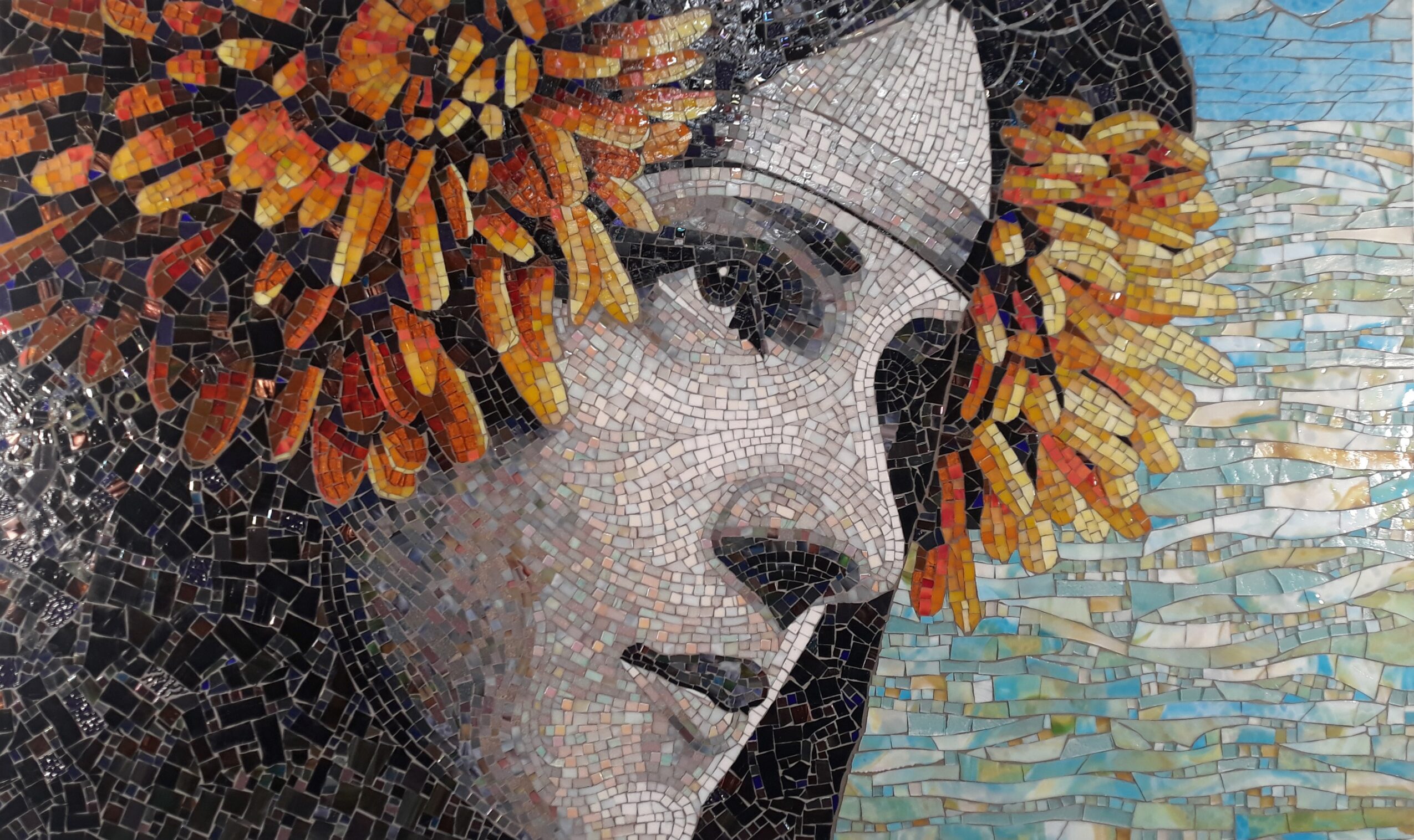 Close-up of a mosaic portrait of a woman with a floral headdress, detailed facial features, and a textured background.