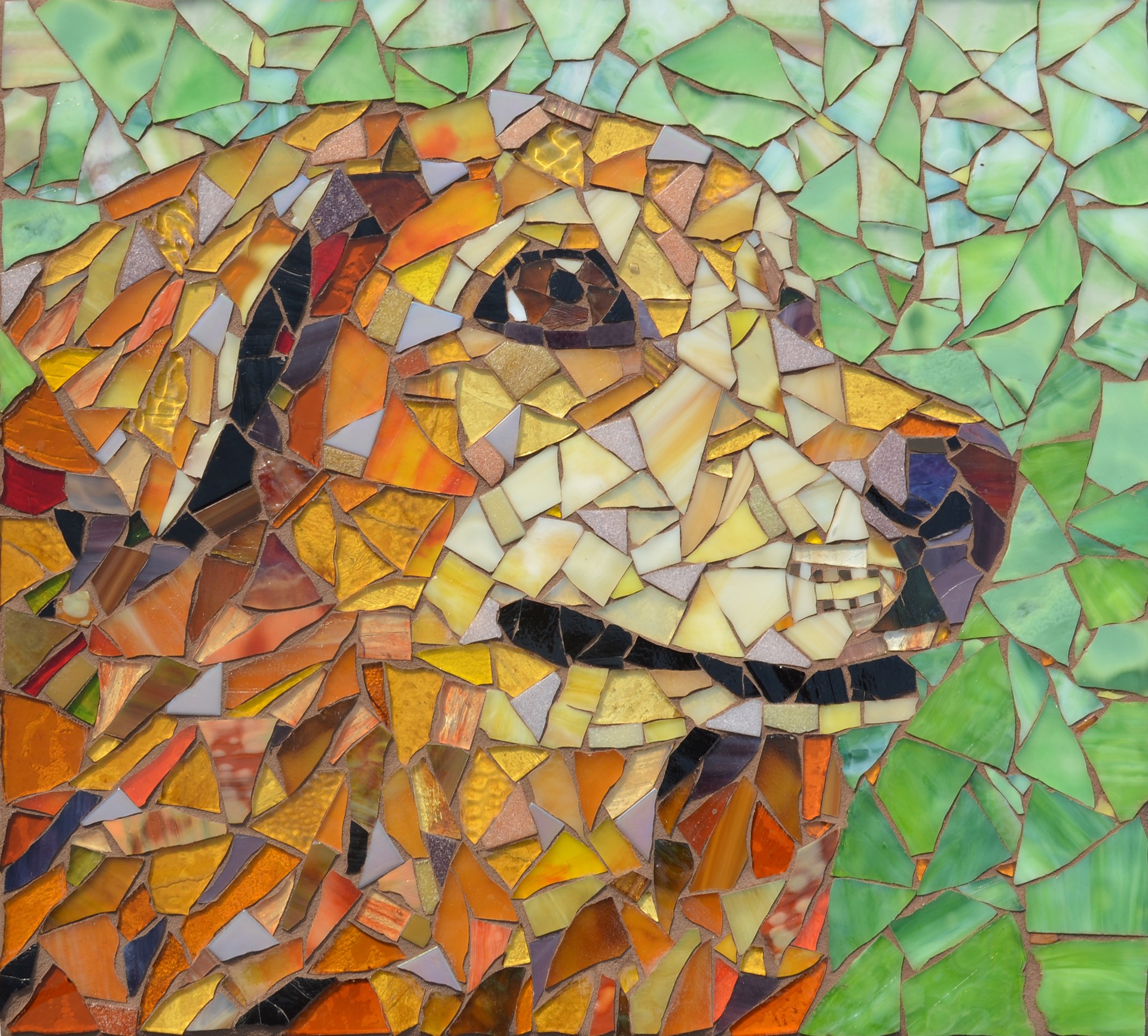 Mosaic of a dog with a green background, composed of various colored tiles, showing the dog's face in profile.