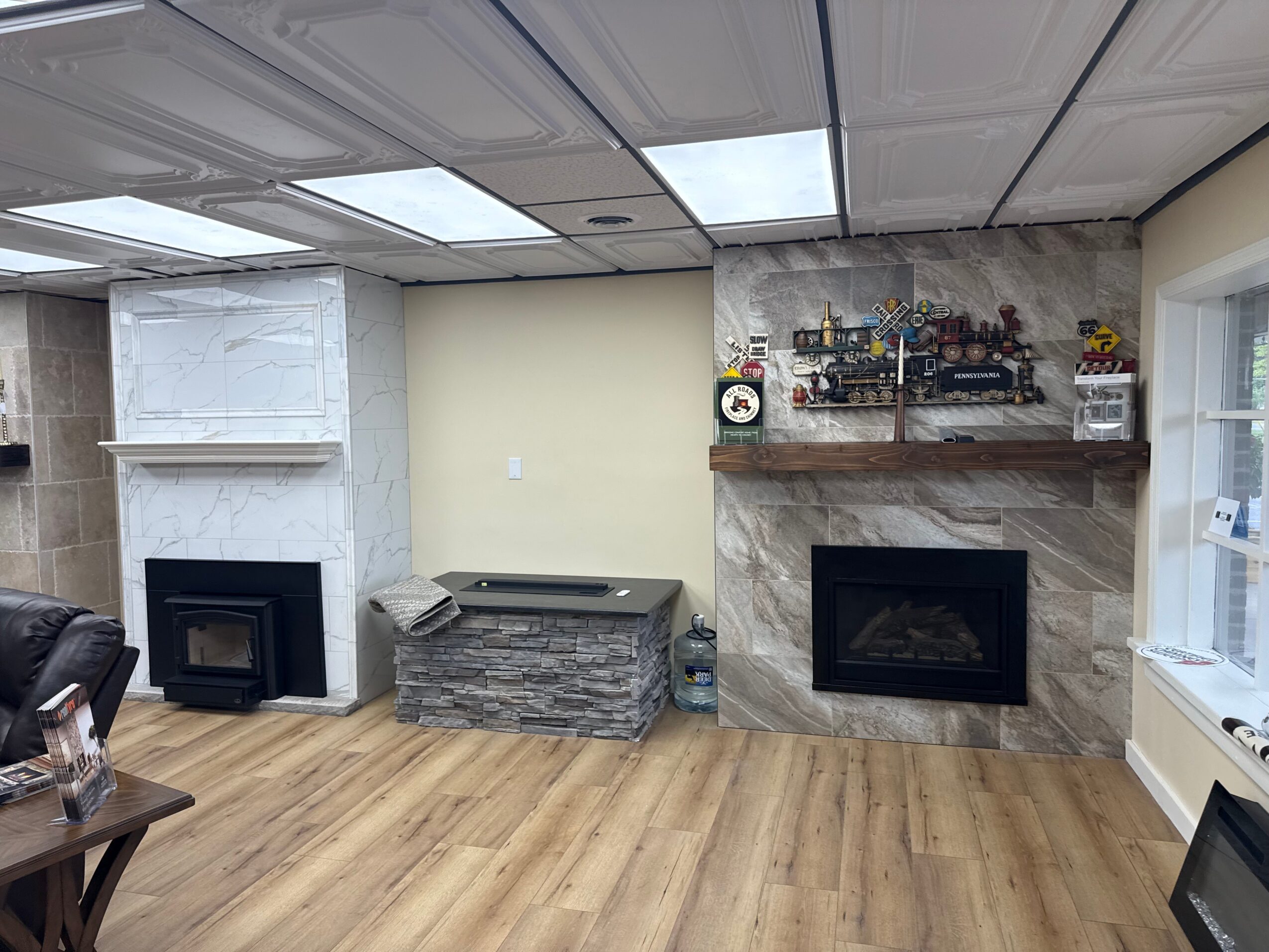 Living room with two fireplaces, a stone coffee table, and a wooden floor.