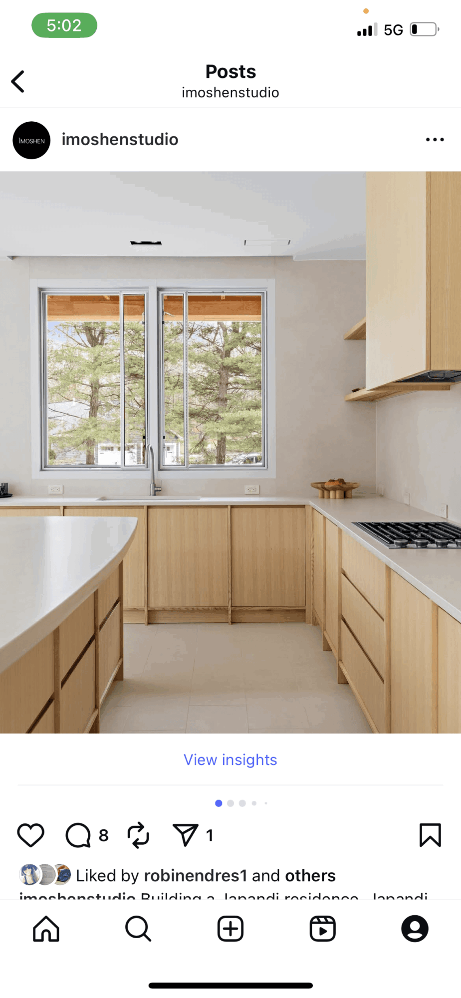 Kitchen with large window, wooden cabinets, and countertop, bright and airy space.