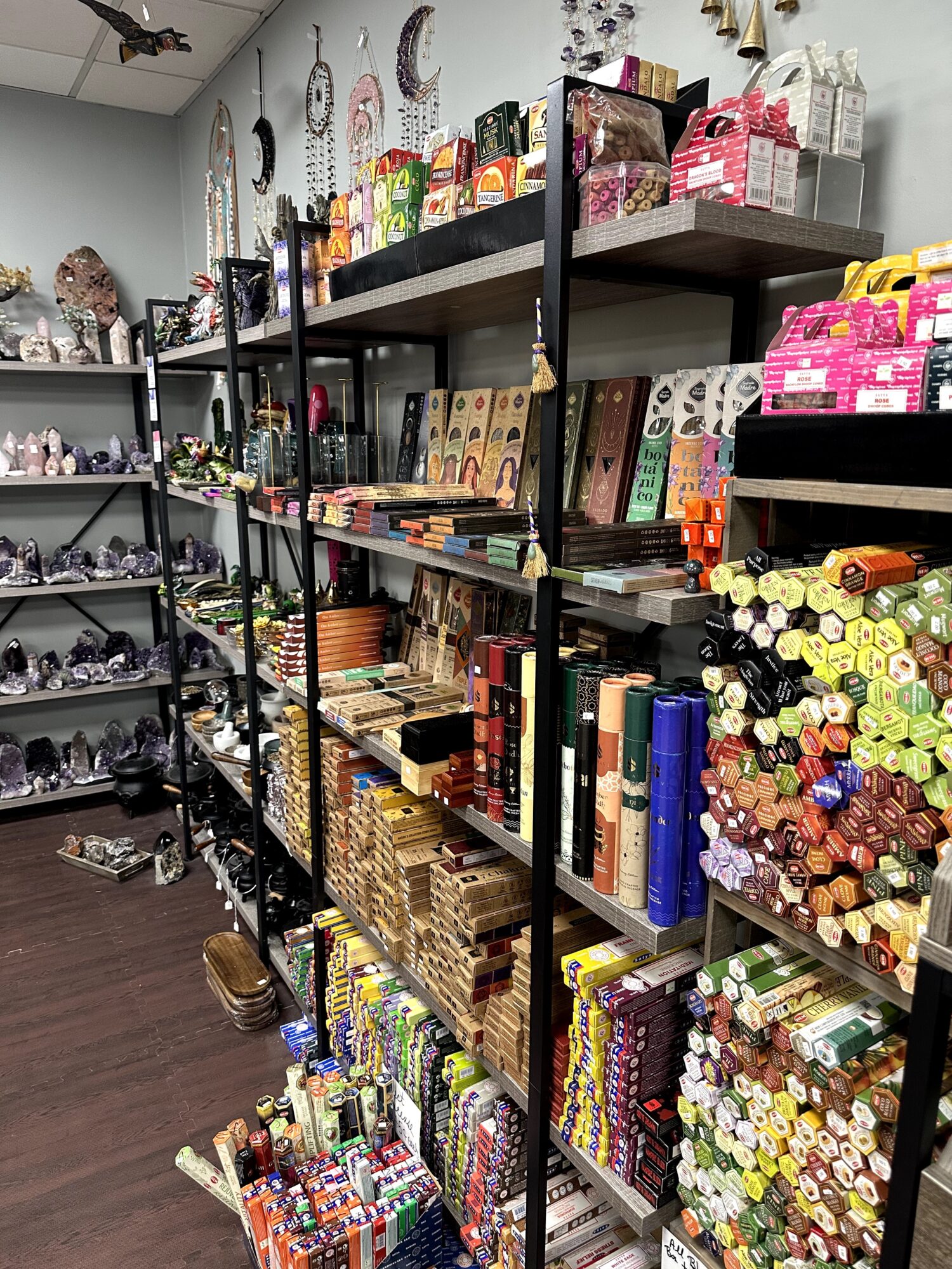 Shelves filled with colorful craft supplies, including paints, markers, and decorative items, in a store setting.
