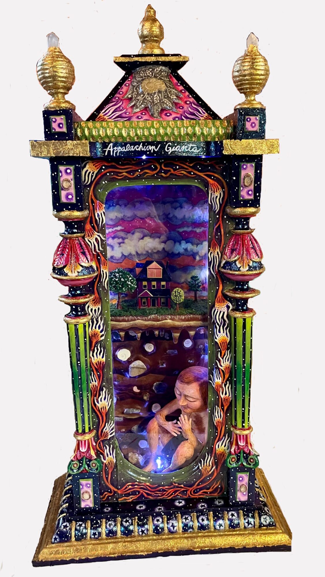 Colorful ornate structure with a glass window showing a scene with a child and glowing objects inside.