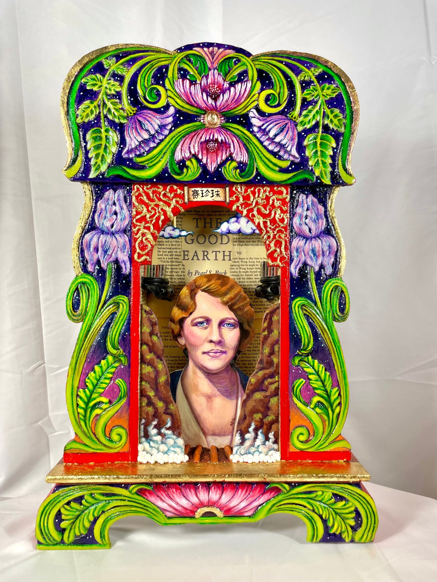Colorful decorative frame with a portrait of a woman, floral patterns, and intricate designs, set against a plain background.