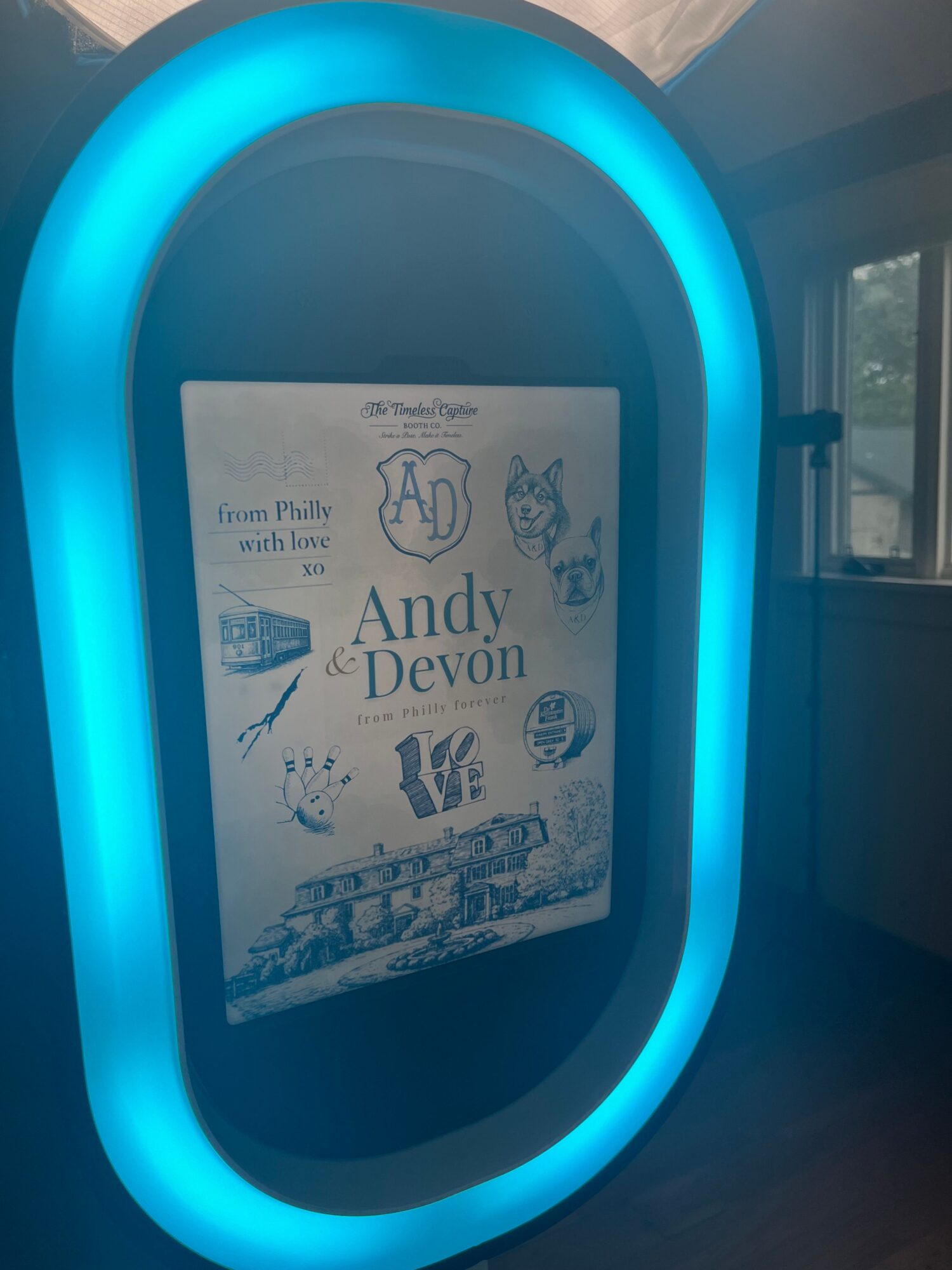 A book titled 'Andy Devon' inside a glowing blue oval frame, with a window in the background.