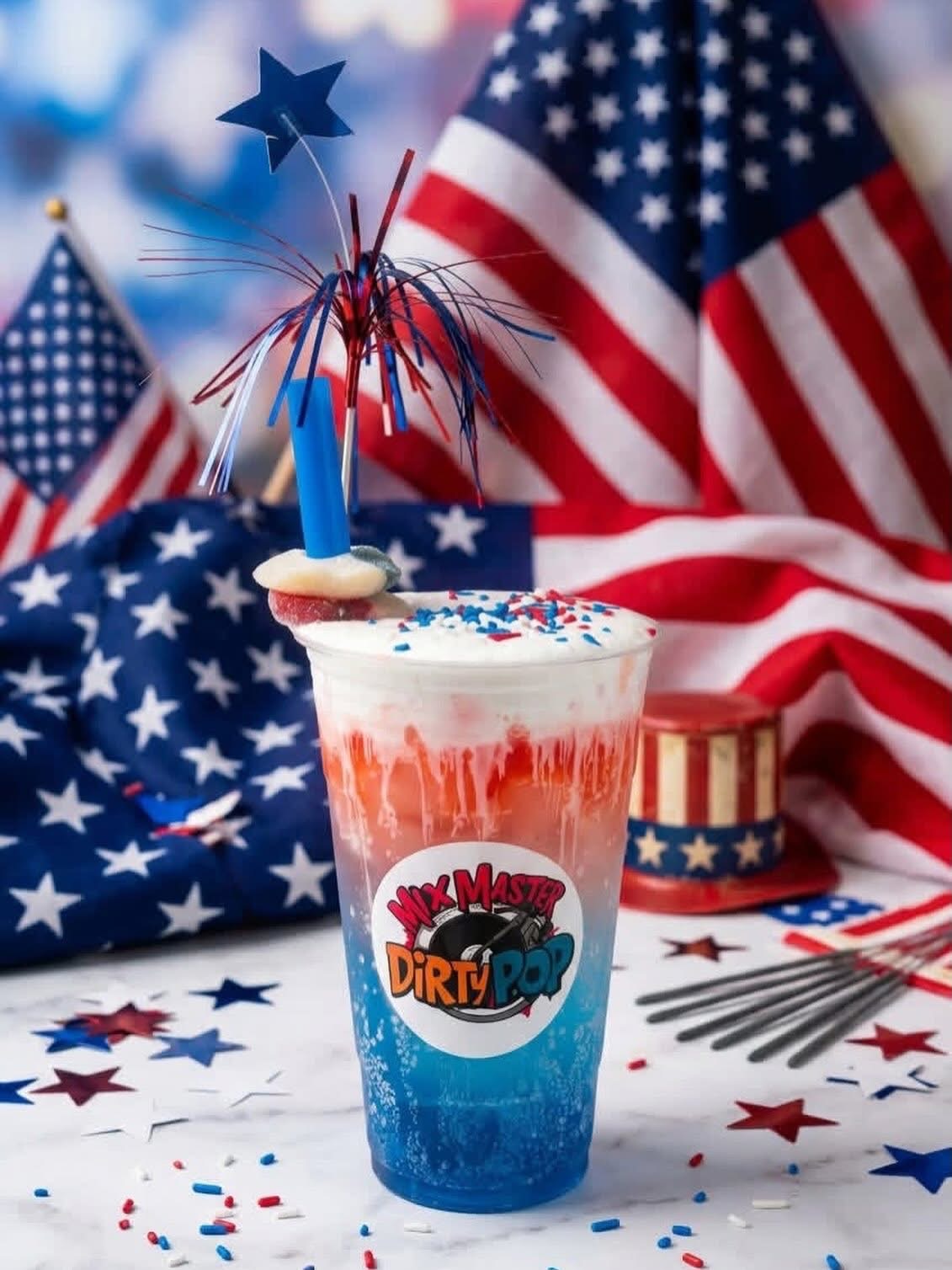 Celebration drink with patriotic decorations, American flags, and star-shaped sparklers, featuring a colorful logo on the cup.