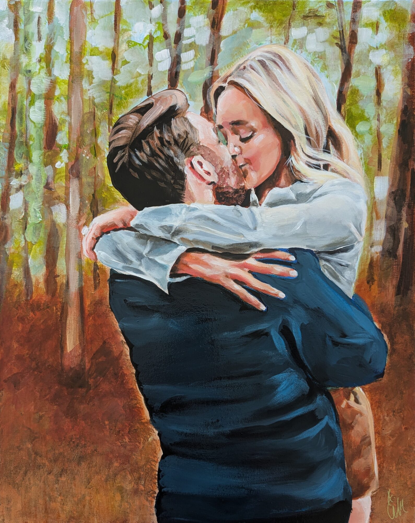 Two people embrace and kiss in a forest with green and brown trees, sunlight filtering through leaves.
