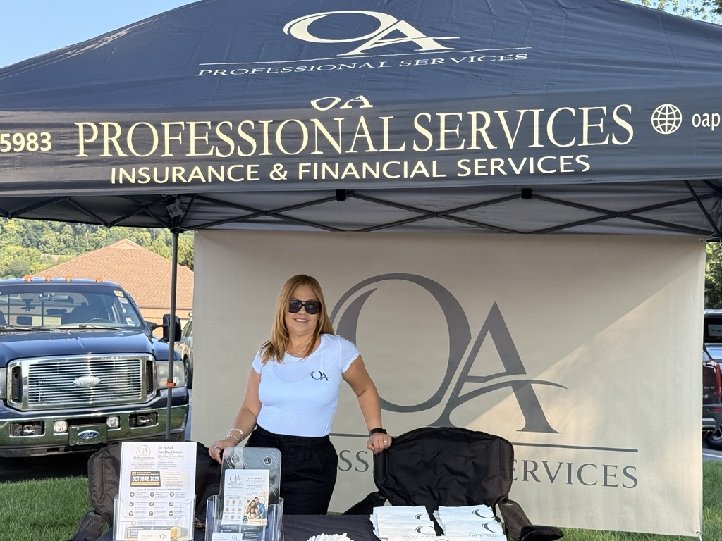 Woman standing under a canopy with 'Professional Services' banner, holding a brochure, with vehicles in the background.