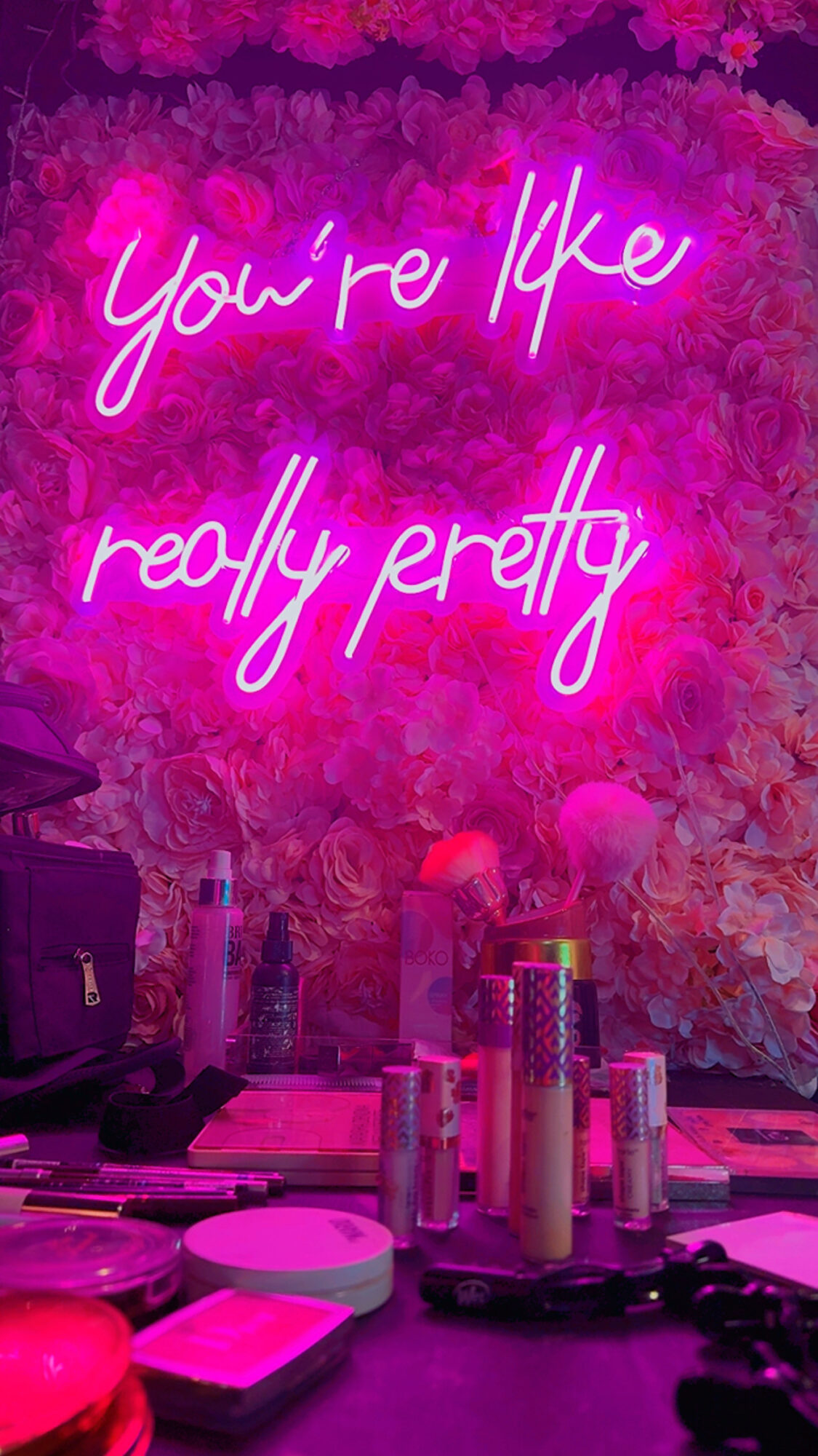 Pink neon sign says