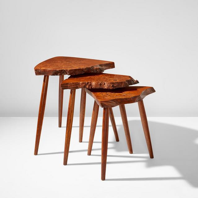 Three wooden stools with irregular, natural wood tops and three legs each, casting shadows on a white background.