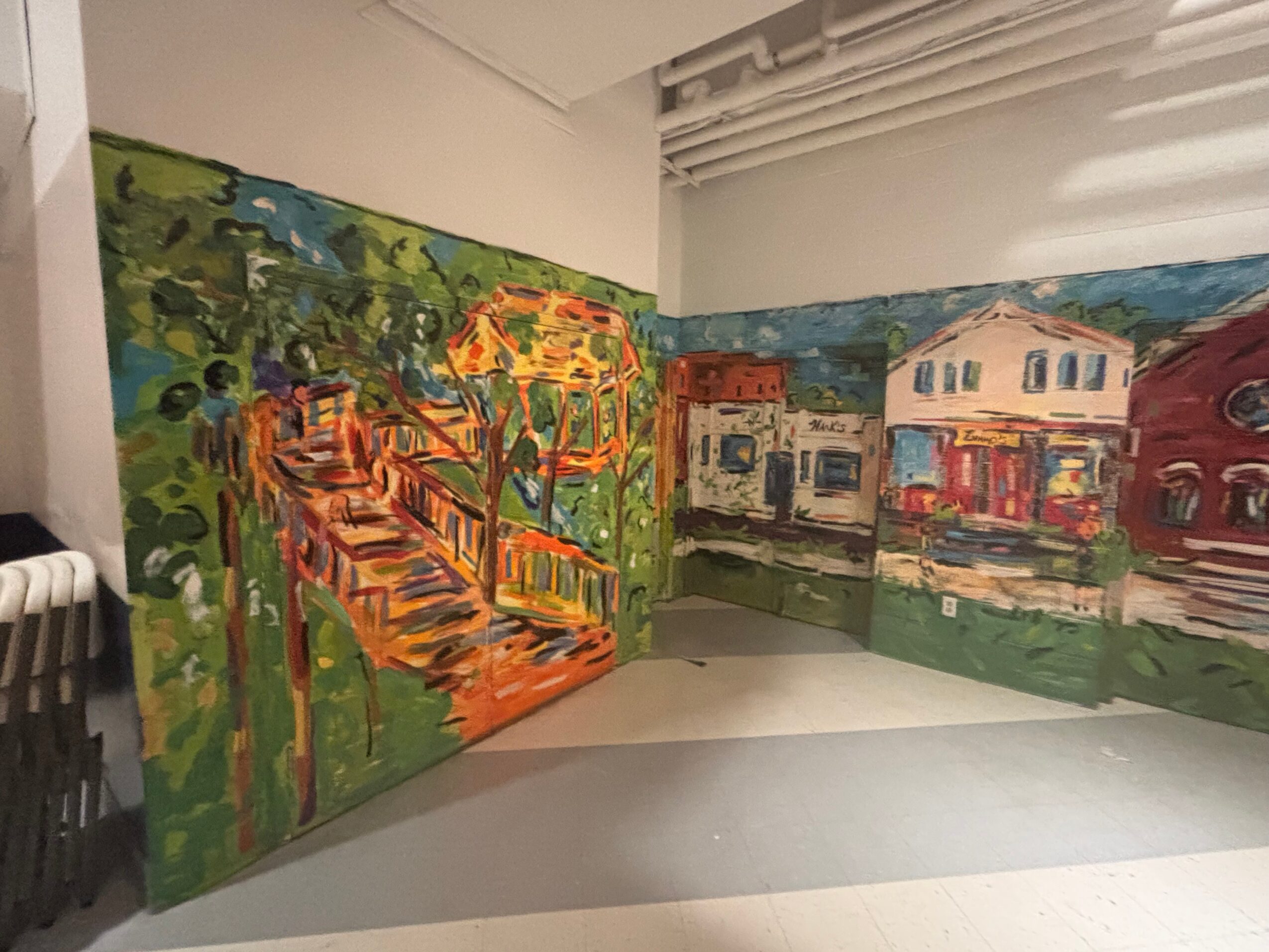 Colorful mural depicting a staircase, trees, and buildings in a vibrant, impressionistic style.
