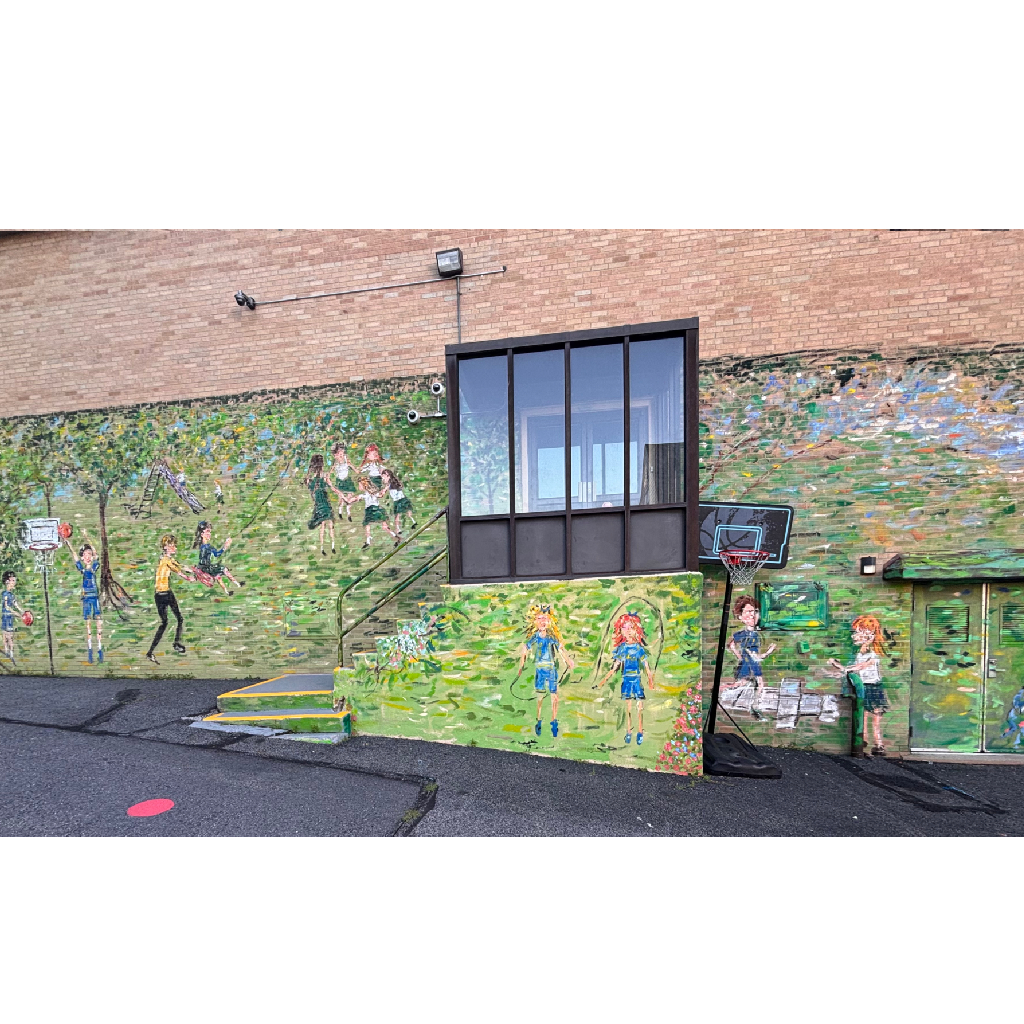 Colorful mural on a brick wall depicts children playing outdoors, with a basketball hoop and stairs in front.