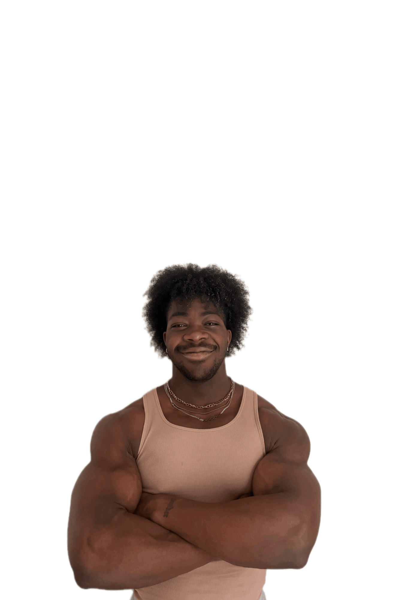 Young man with curly hair smiling, arms crossed, wearing a beige sleeveless top, against a white background.