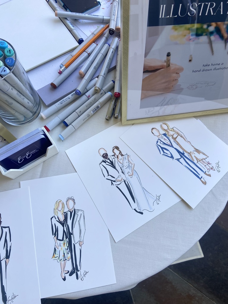 Sketches of fashion designs featuring women in stylish outfits on white paper, with drawing tools and a framed illustration in the background.