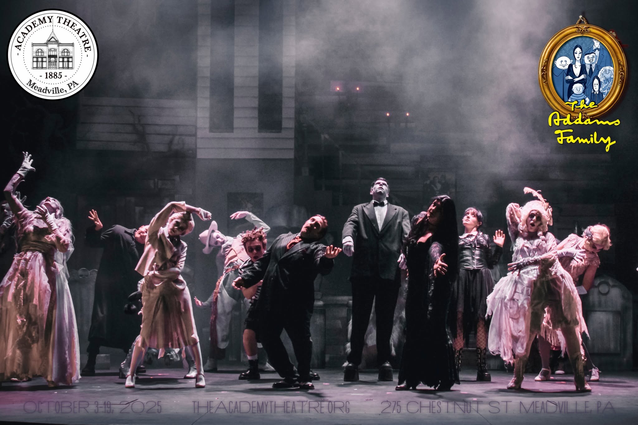 Group of performers on stage in period costumes, some dancing, with a dark background and theatrical lighting.
