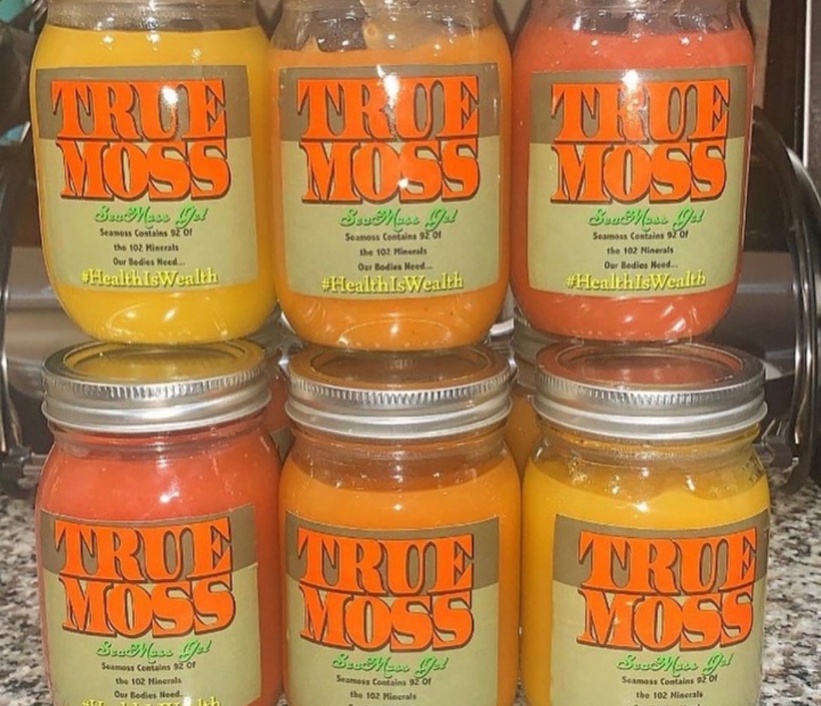 Six jars of flavored honey with orange labels, arranged in two rows, with green and orange labels visible.