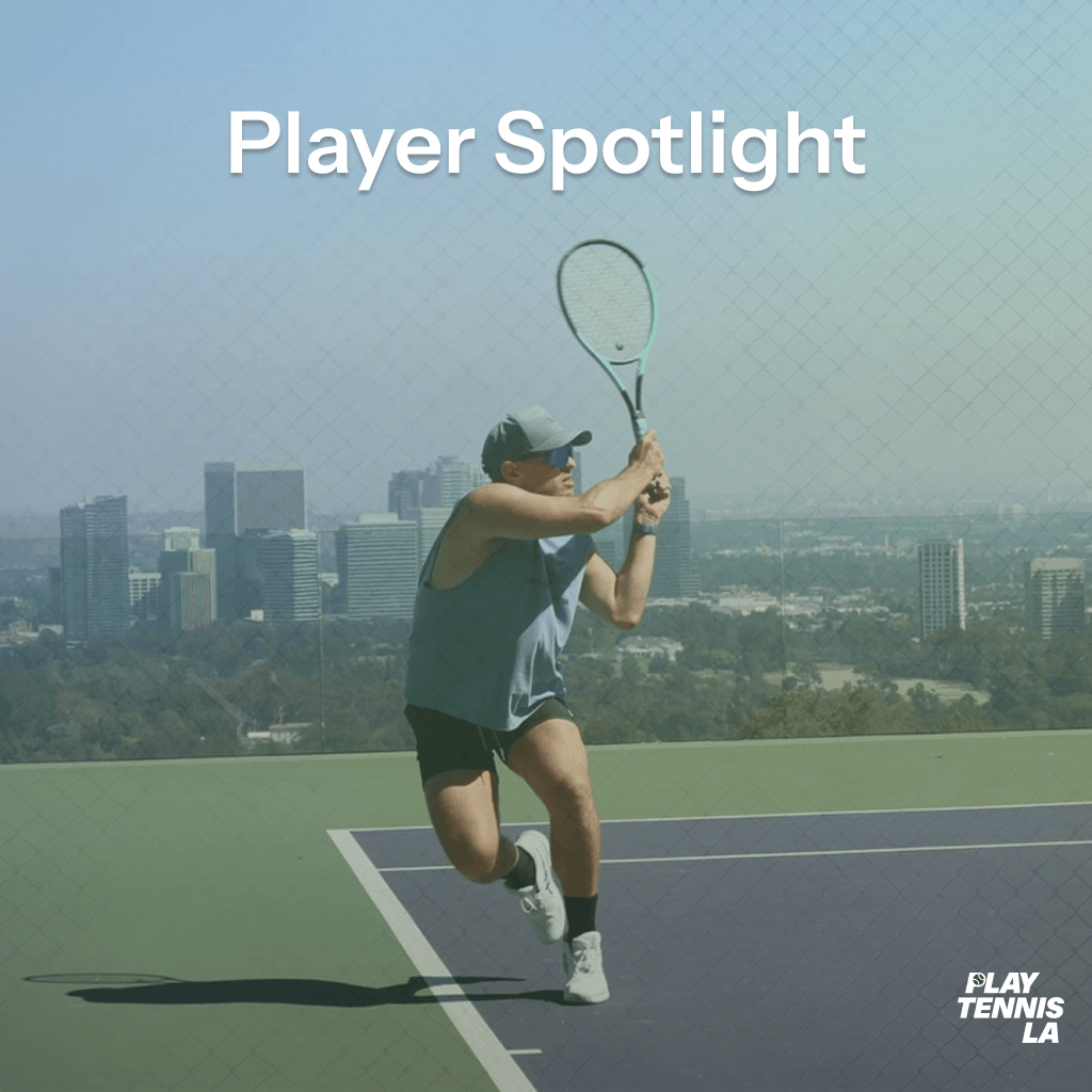 Person playing tennis on a court with city skyline in background, holding a racket, preparing to hit the ball.
