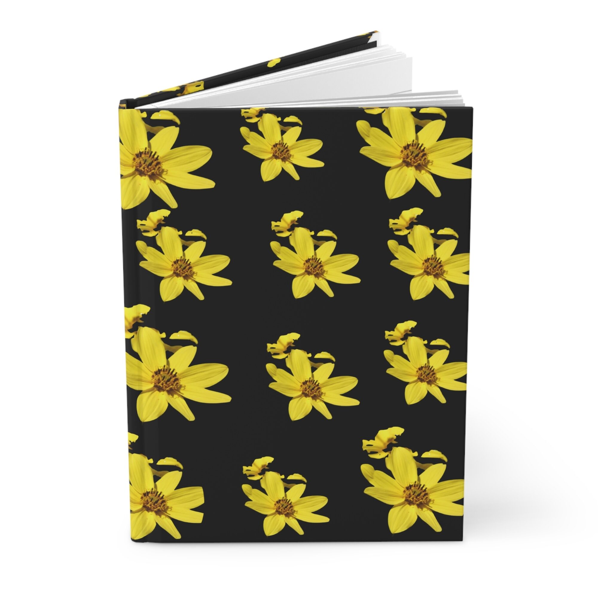 Notebook with a black cover decorated with yellow flowers, open to show white pages inside.