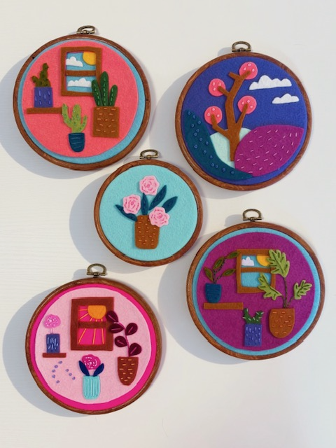 Five embroidered circular patches with colorful plant and nature designs, arranged on a white background.