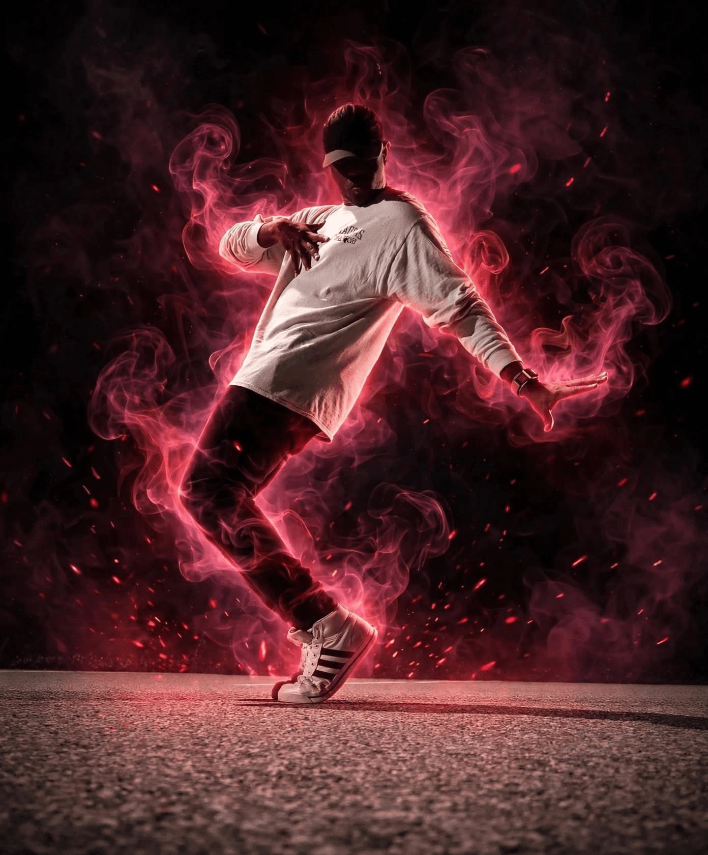 Person dancing with pink smoke effects, wearing a white shirt and sneakers, on a dark background.