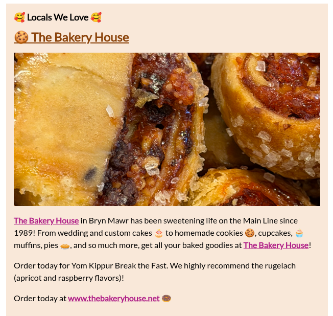 Close-up of baked goods, including a cinnamon roll and a pastry with fruit filling, on a plate.