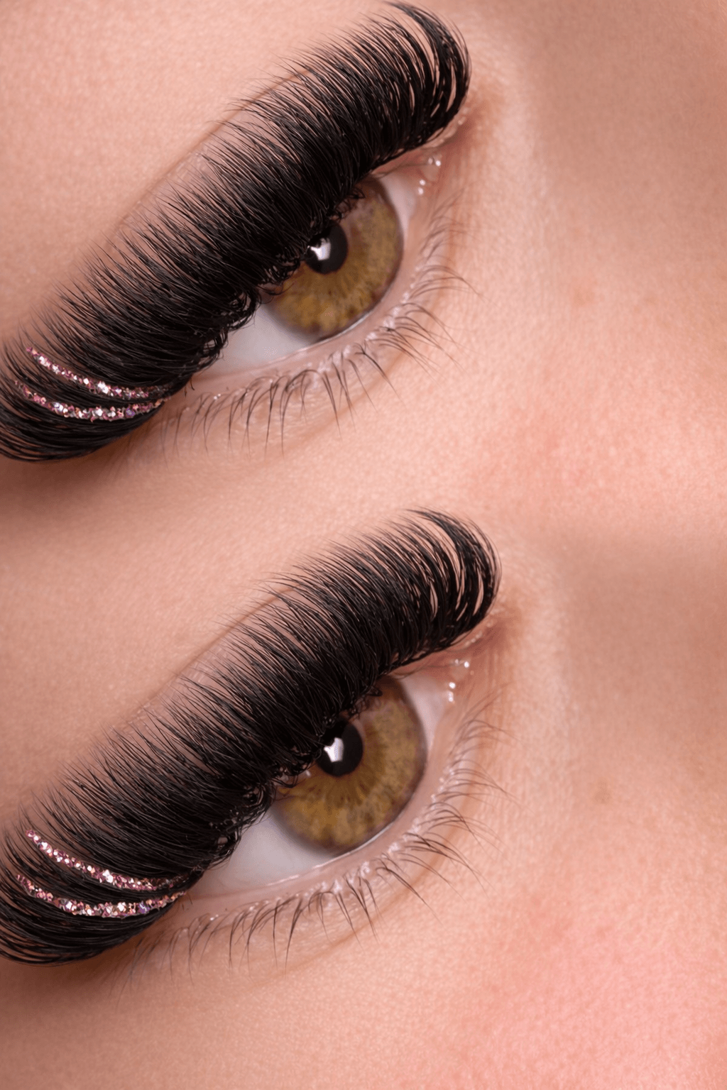 Close-up of two eyes with long, thick eyelashes and brown irises, showing makeup details.