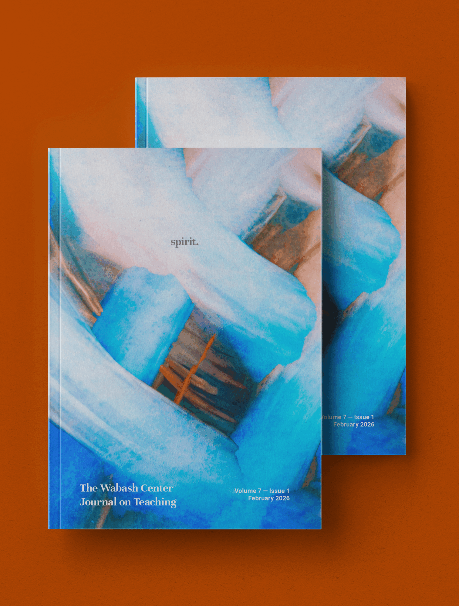 Two books with abstract blue and white cover art, placed on a brown surface, with the word 'spirit' visible on one.