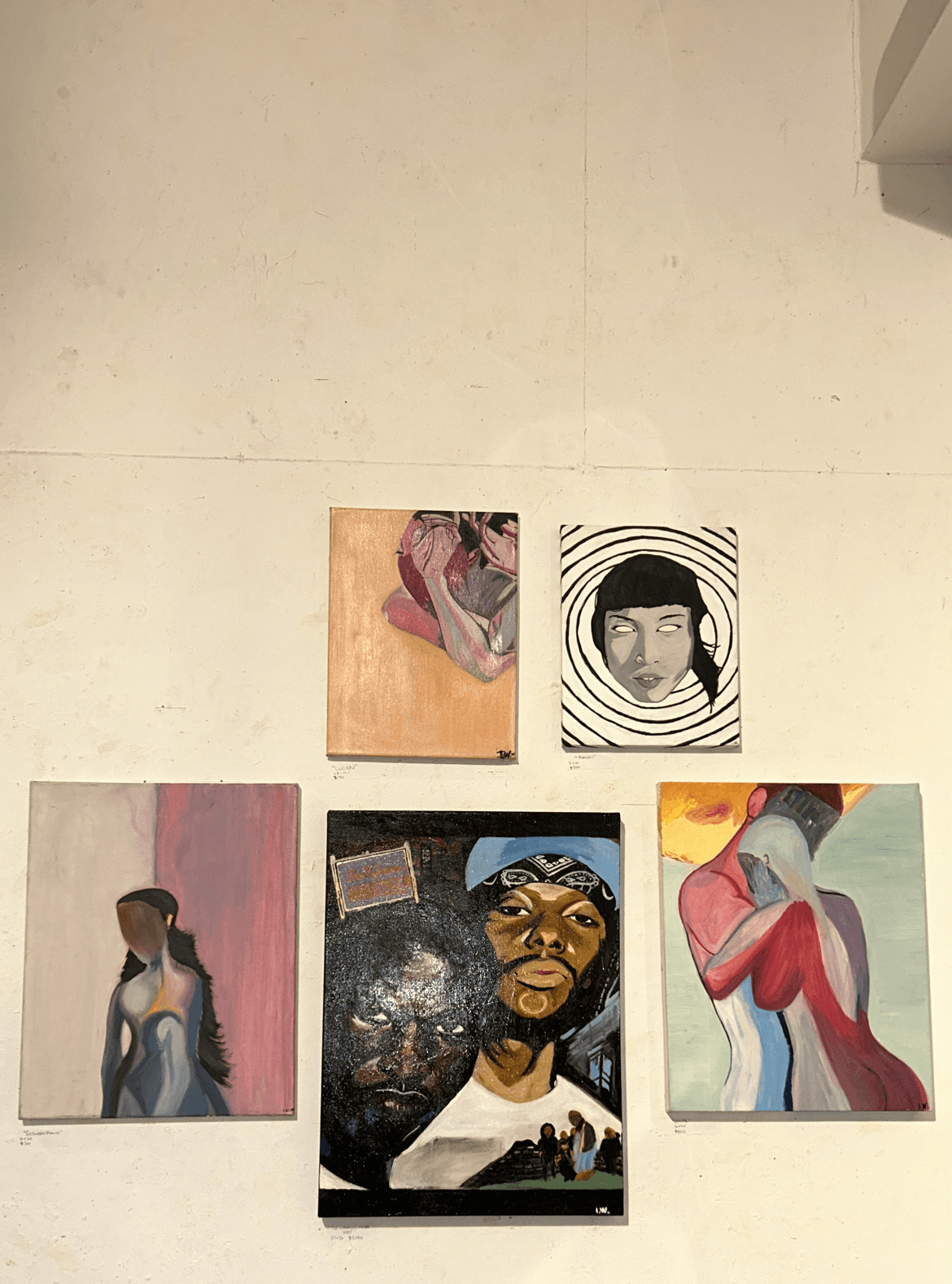 Six portraits of people, some with artistic backgrounds, arranged in two rows on a plain wall.