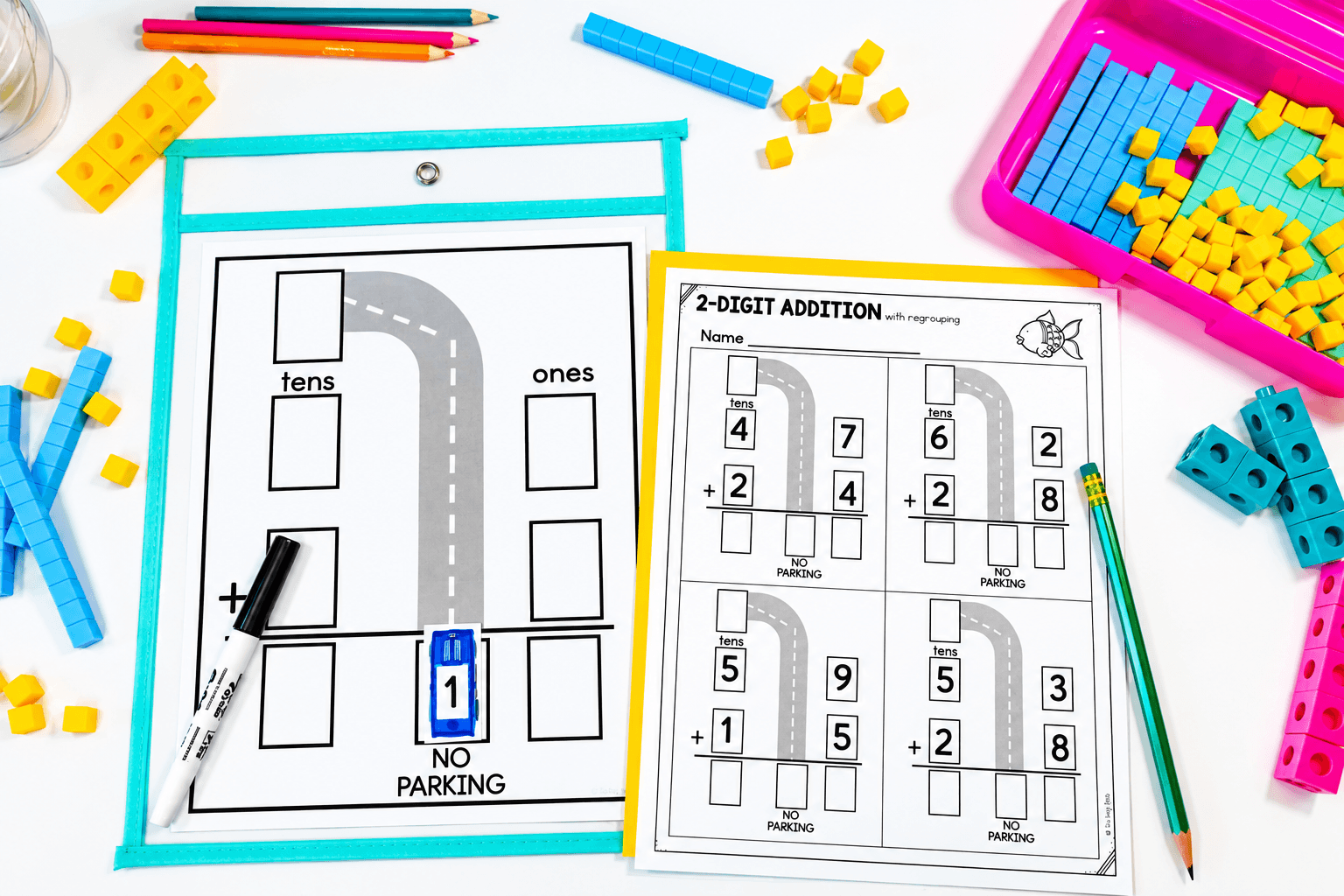 Educational math activity with number blocks, worksheets, and colorful tools on a white surface.
