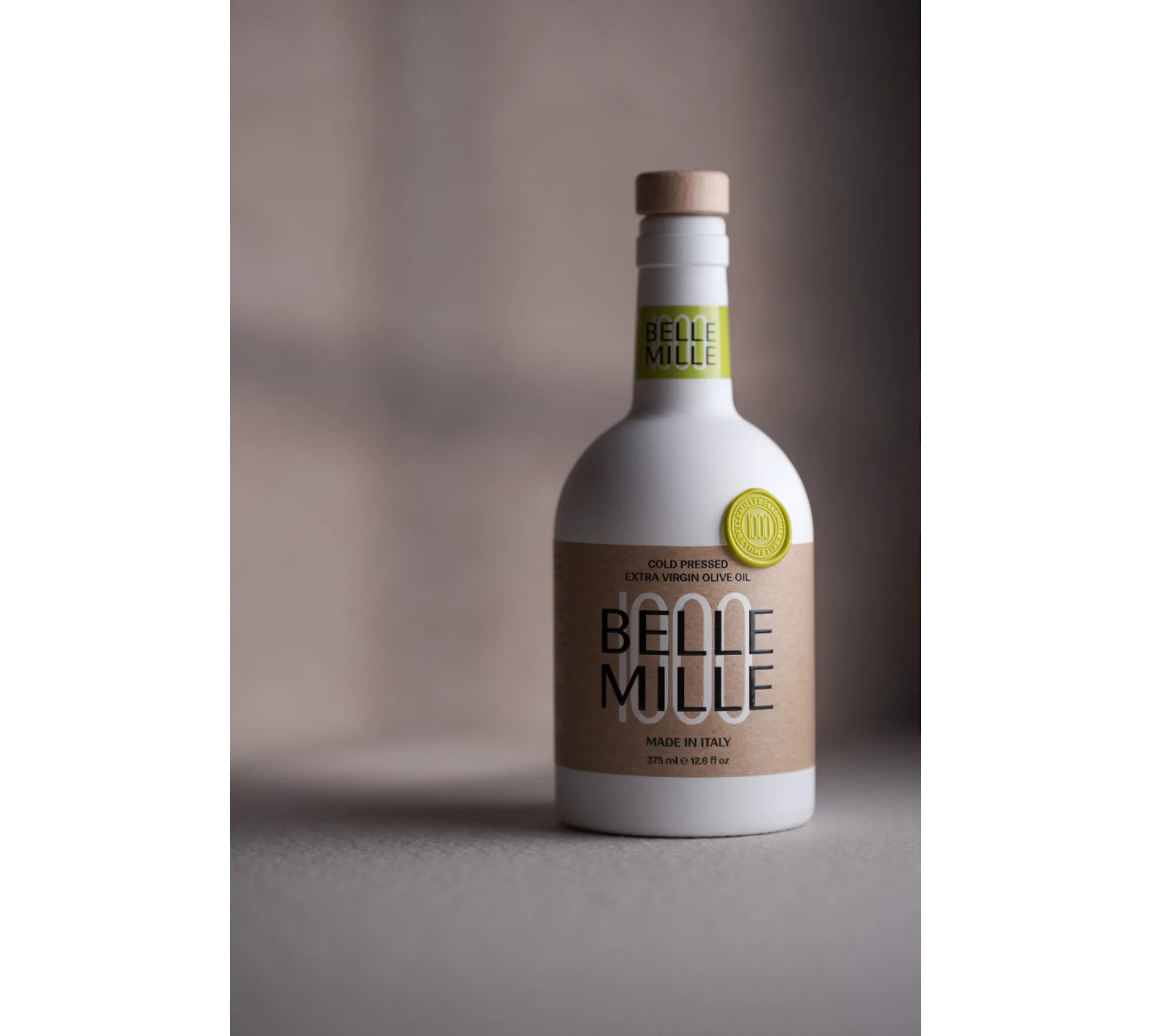 White bottle with a beige cap and label, standing on a surface with a plain background.