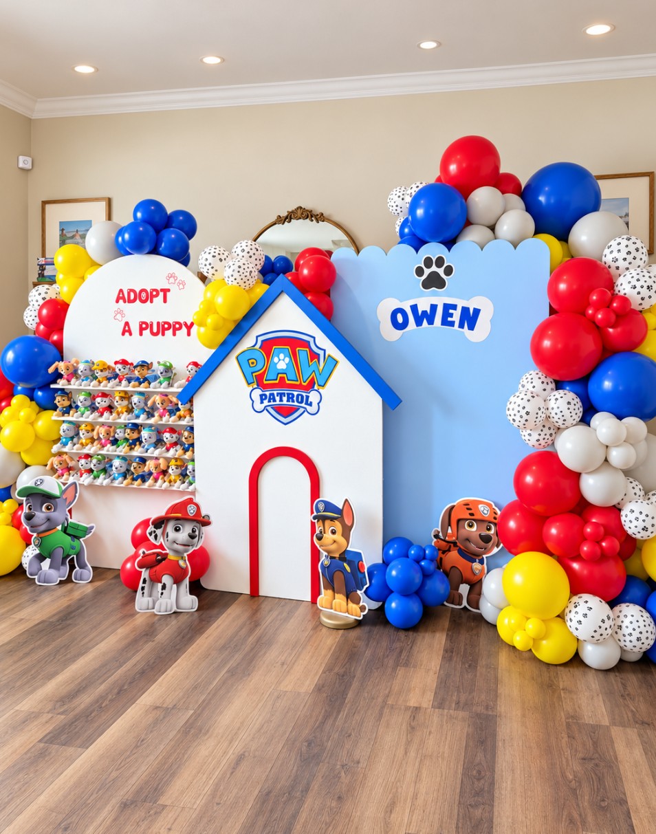 Paw Patrol-themed birthday display with balloons, character cutouts, and a sign for Owen's birthday, decorated with red, blue, yellow, and white balloons.